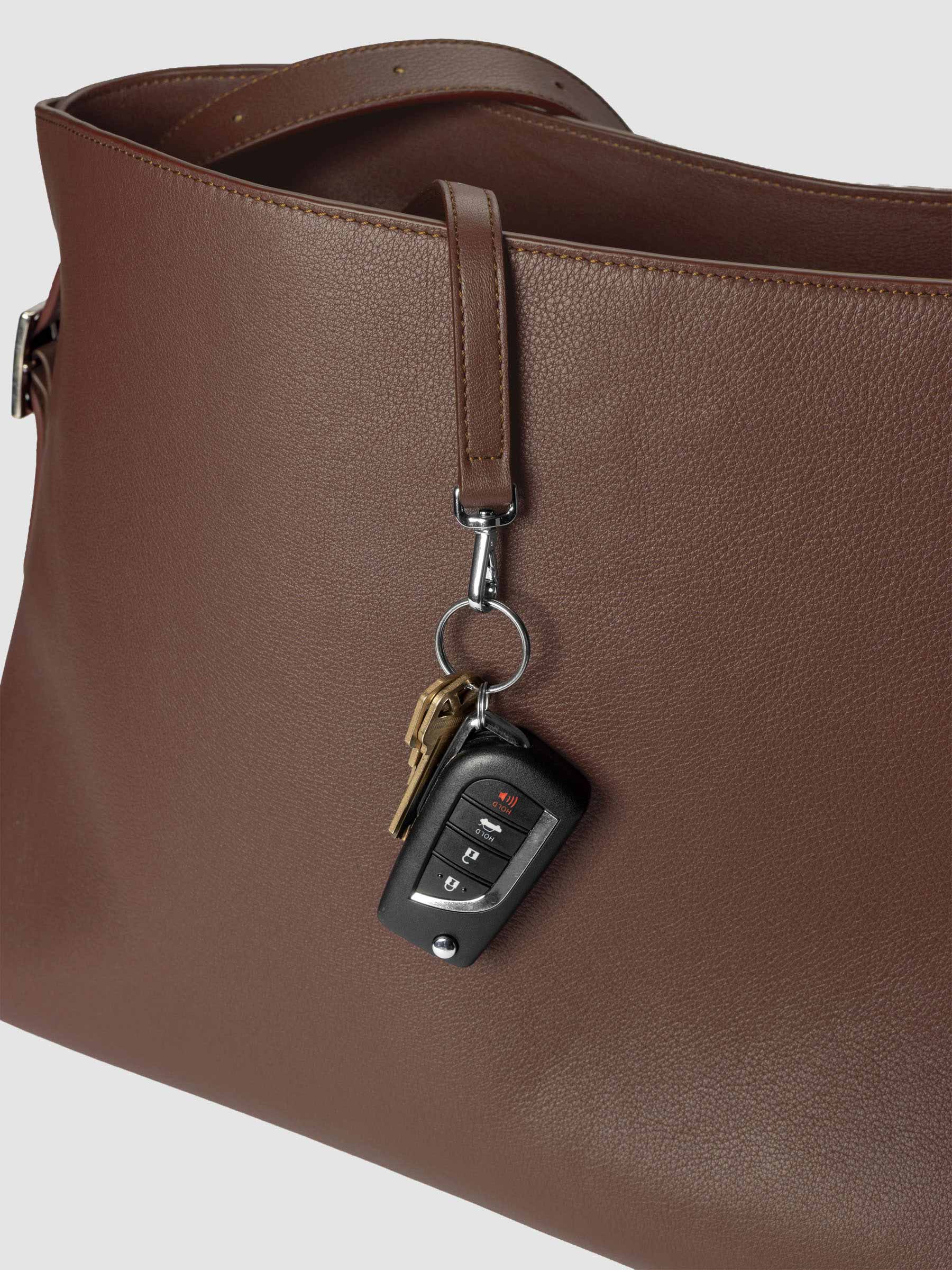 Detail view of the key leash with keys attached on The Metro Tote in the color Cordoba.