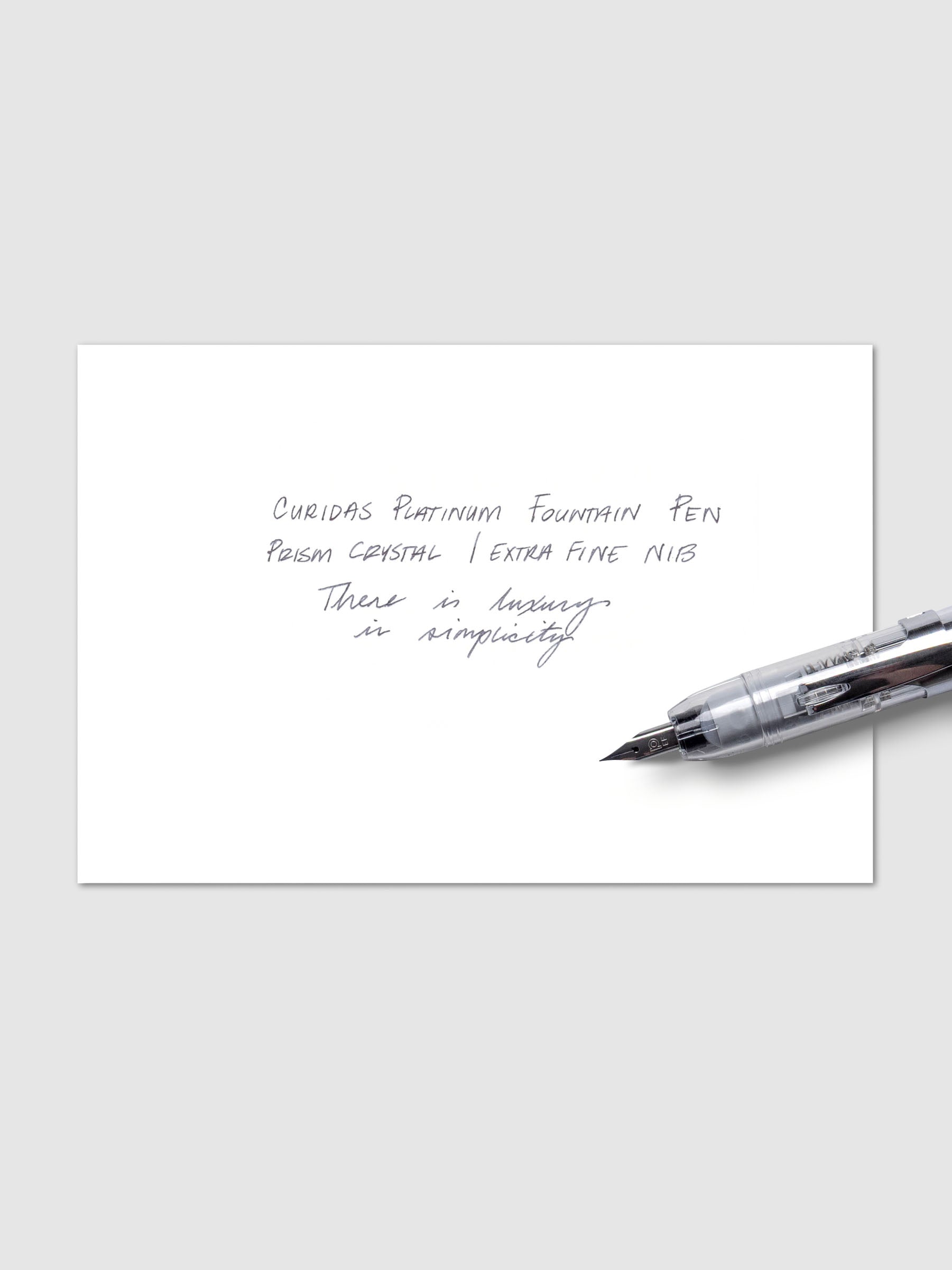 Writing sample with Platinum Curidas pen shown on a neutral background. Ink color is black.