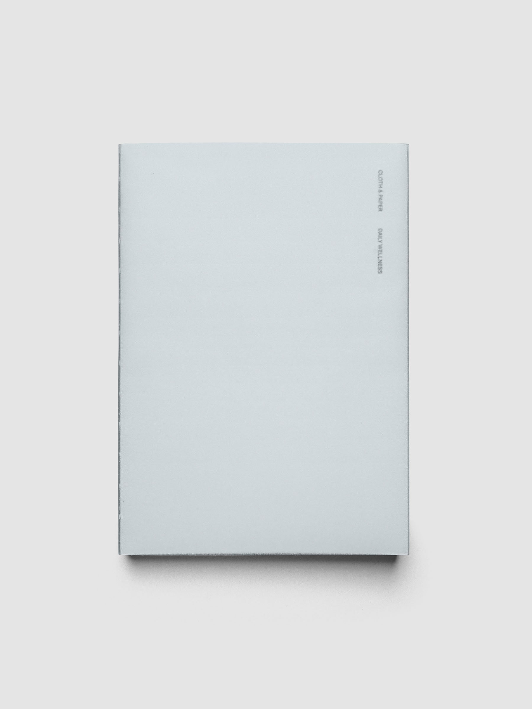 Perfect Bound Notebook | A5 | Daily Wellness shown closed on a neutral background, plain light blue cover