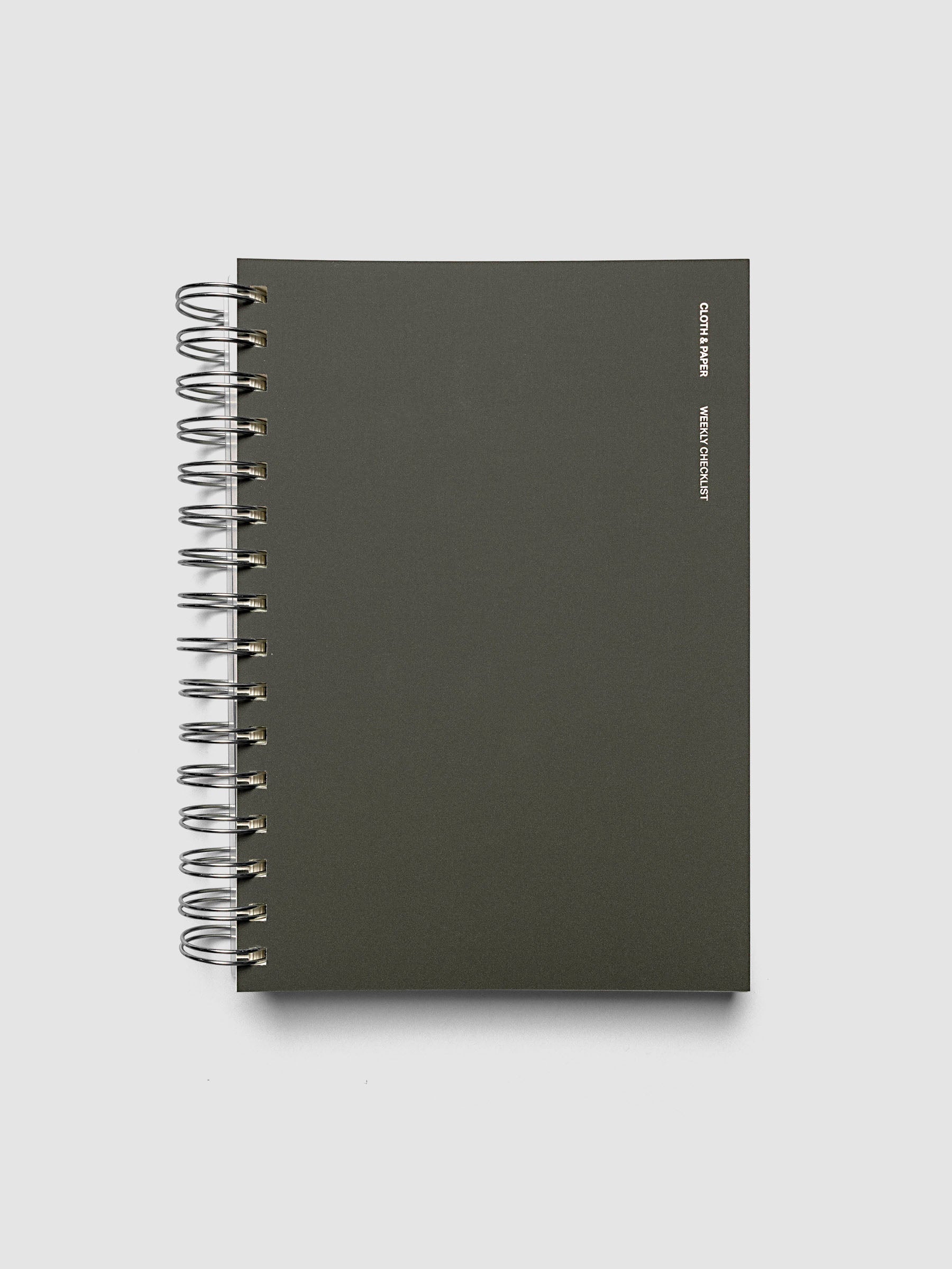 Spiral Notebook | A5 | Weekly Checklist shown closed on a neutral background, plain dark olive cover with silver spiral binding