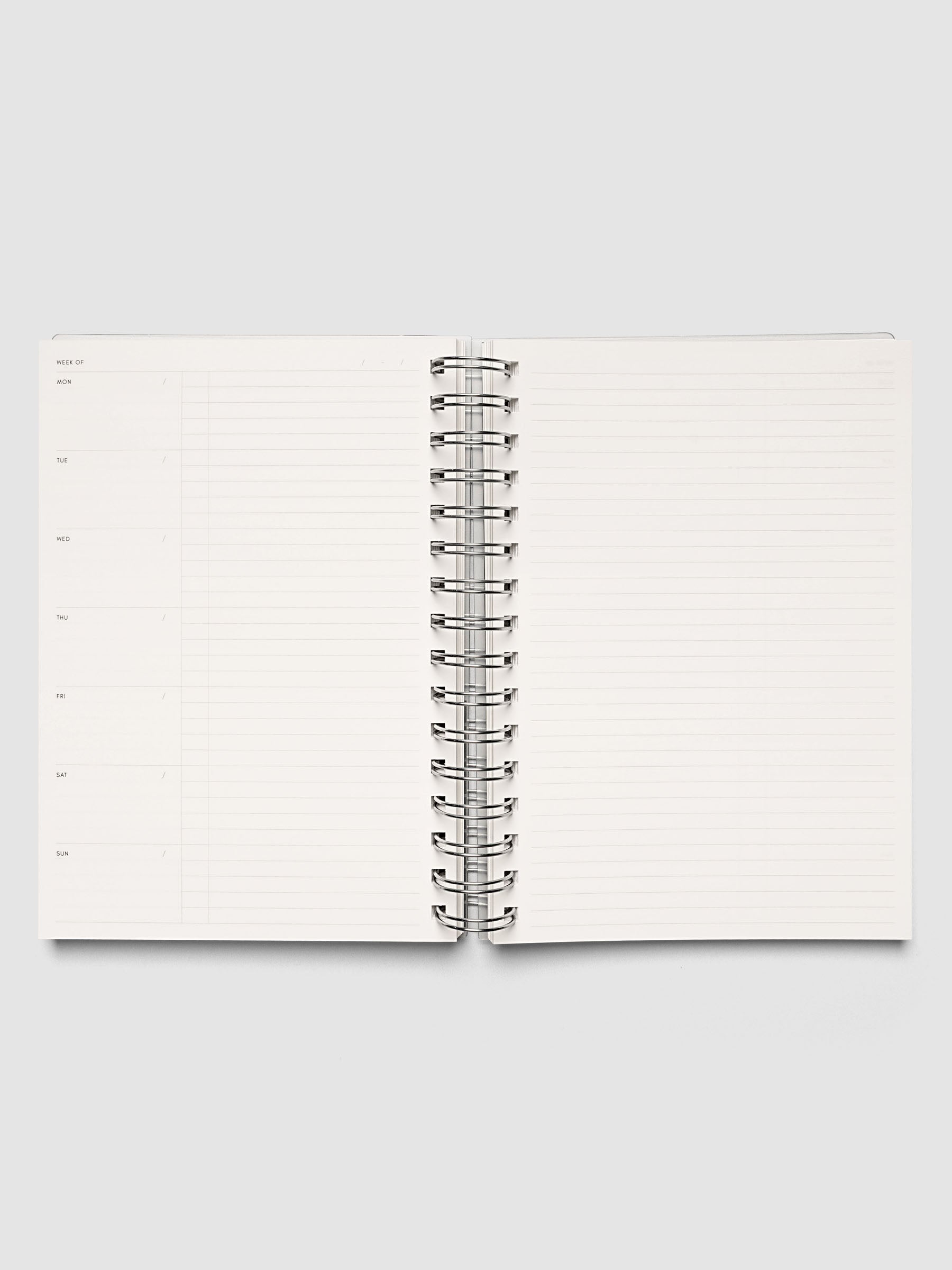Spiral Notebook | A5 | Weekly Checklist shown open and laid flat, both pages ruled for weekly checklists with silver spiral binding at the center