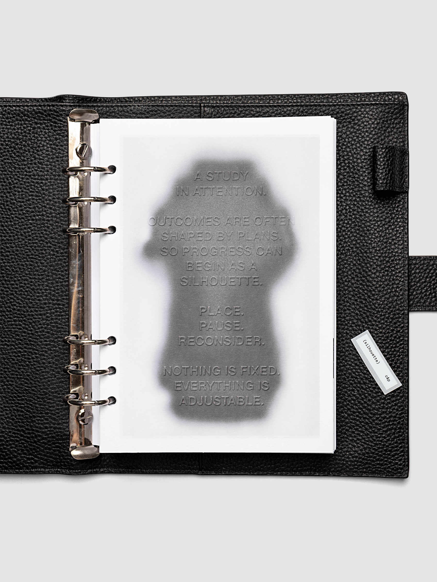 Silhouette Planner Dashboard in A5 6-Ring Punch. Greyscale silhouette print with embossed text on paper. Image 2 of 4.