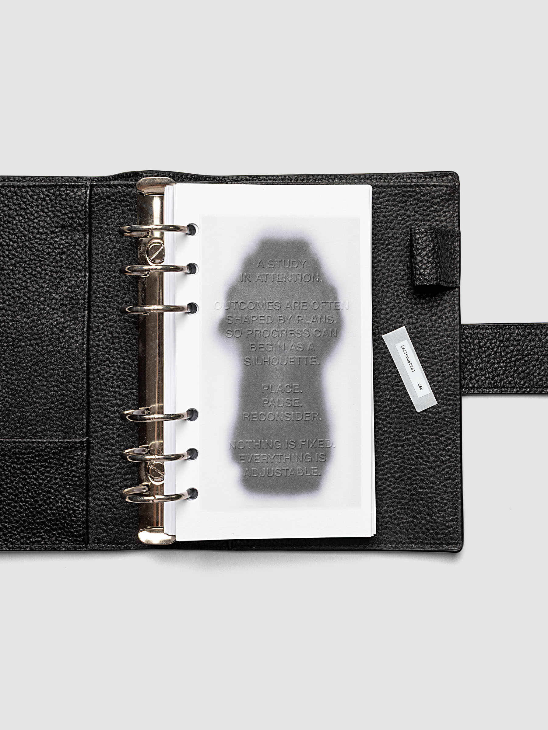 Silhouette Planner Dashboard in Personal. Greyscale silhouette print with embossed text on paper. Image 2 of 2.
