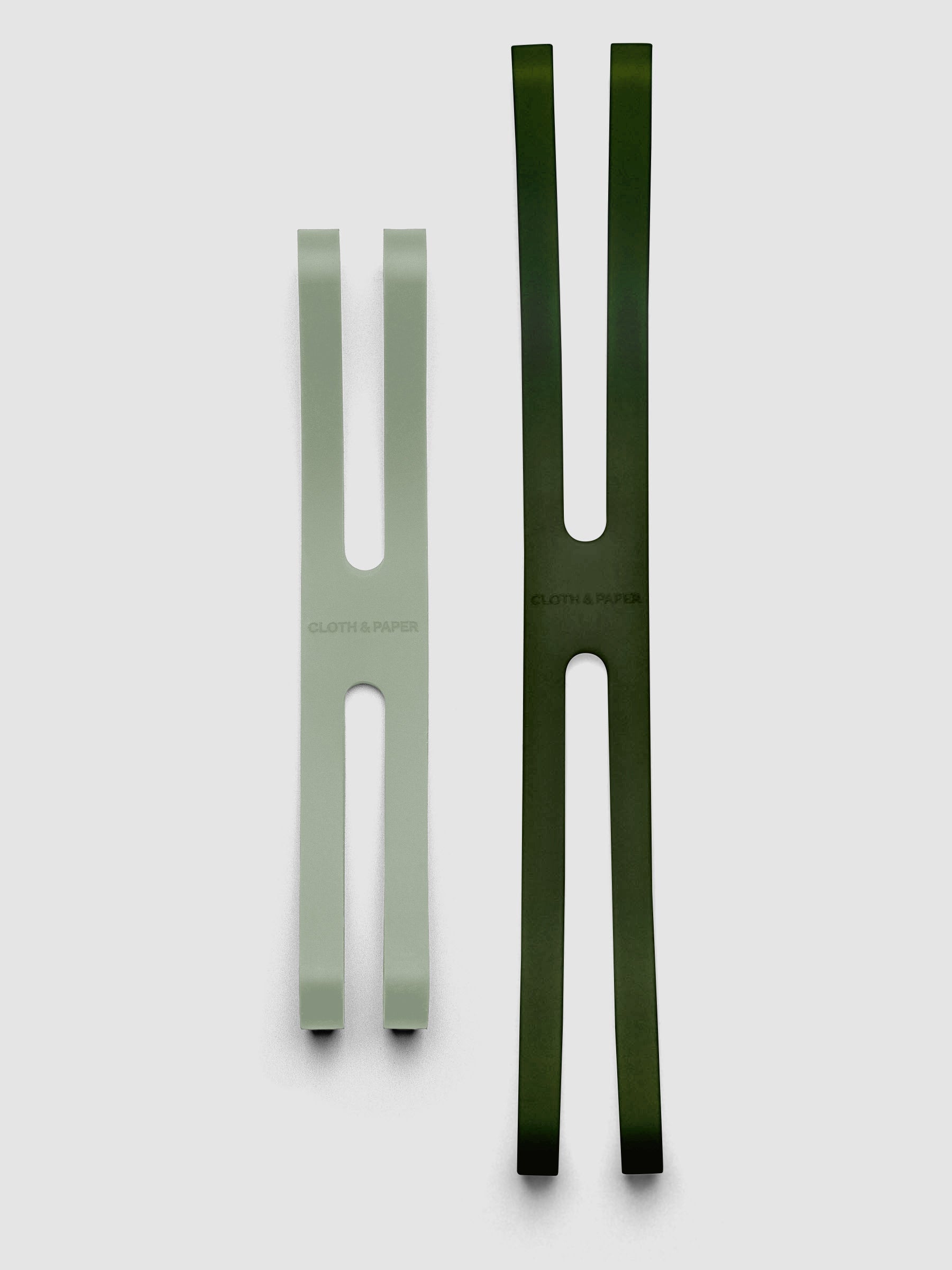 Small matcha and large olive planner closure bands shown side by side for size comparison.
