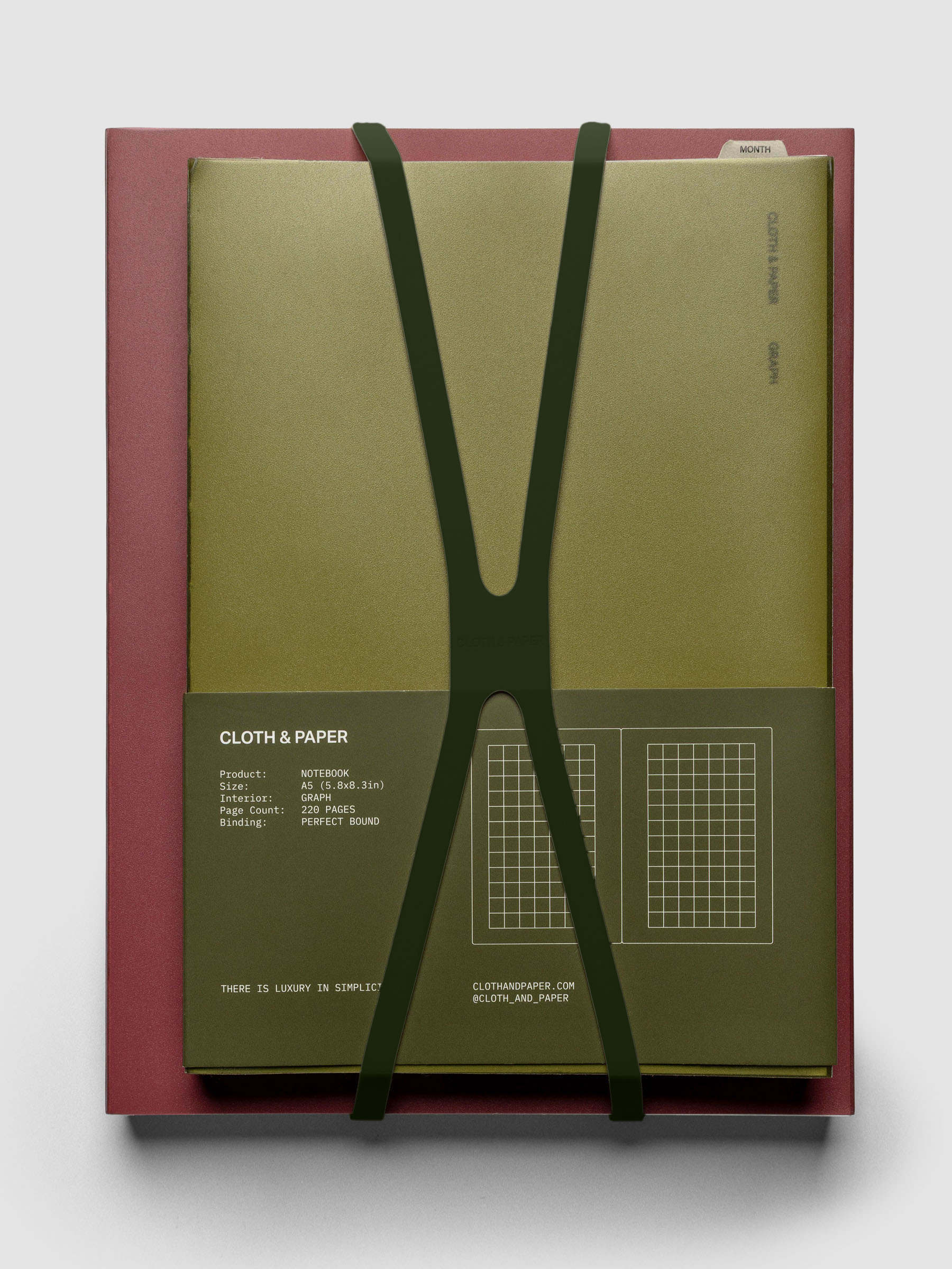 Large olive planner closure band holding an A5 perfect bound notebook.