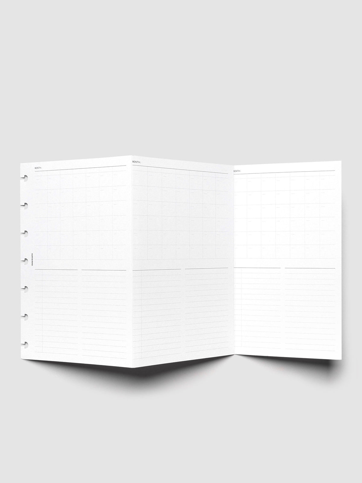 Monthly Fold Out Planner Insert Set of 2, HP Mini 7-Disc Punch, the insert unfolded and propped upright, three monthly calendar panels each above lined writing space