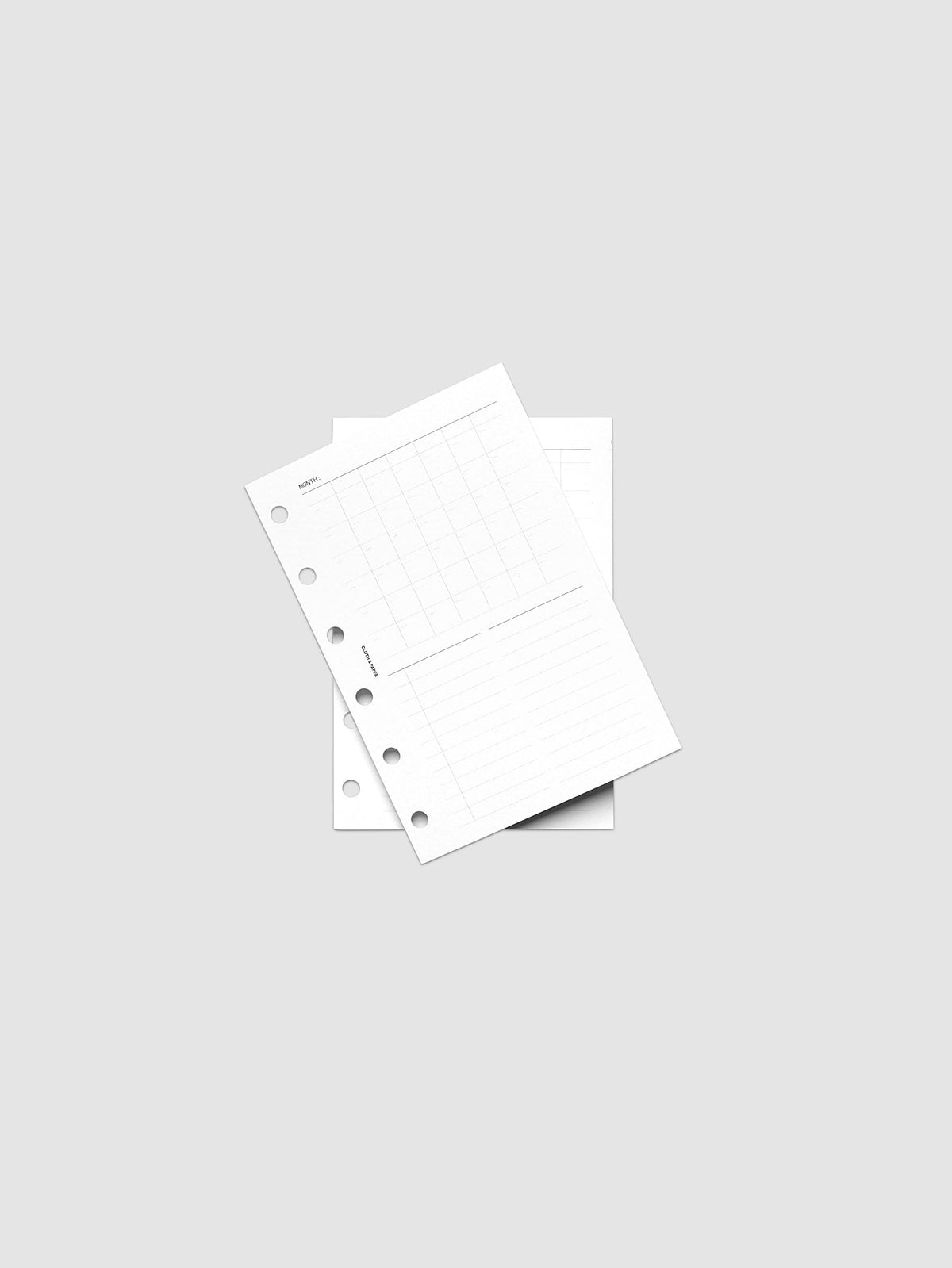 Monthly Fold Out Planner Insert Set of 2, Pocket 6-Ring Punch, both inserts of the set layered at an angle on a pale gray surface