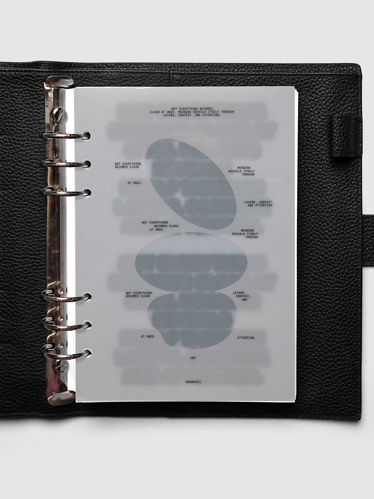 Nuanced Dashboard Trio, A5 6-Ring Punch, dashboard clipped into a black pebbled leather planner with silver rings, seen straight on