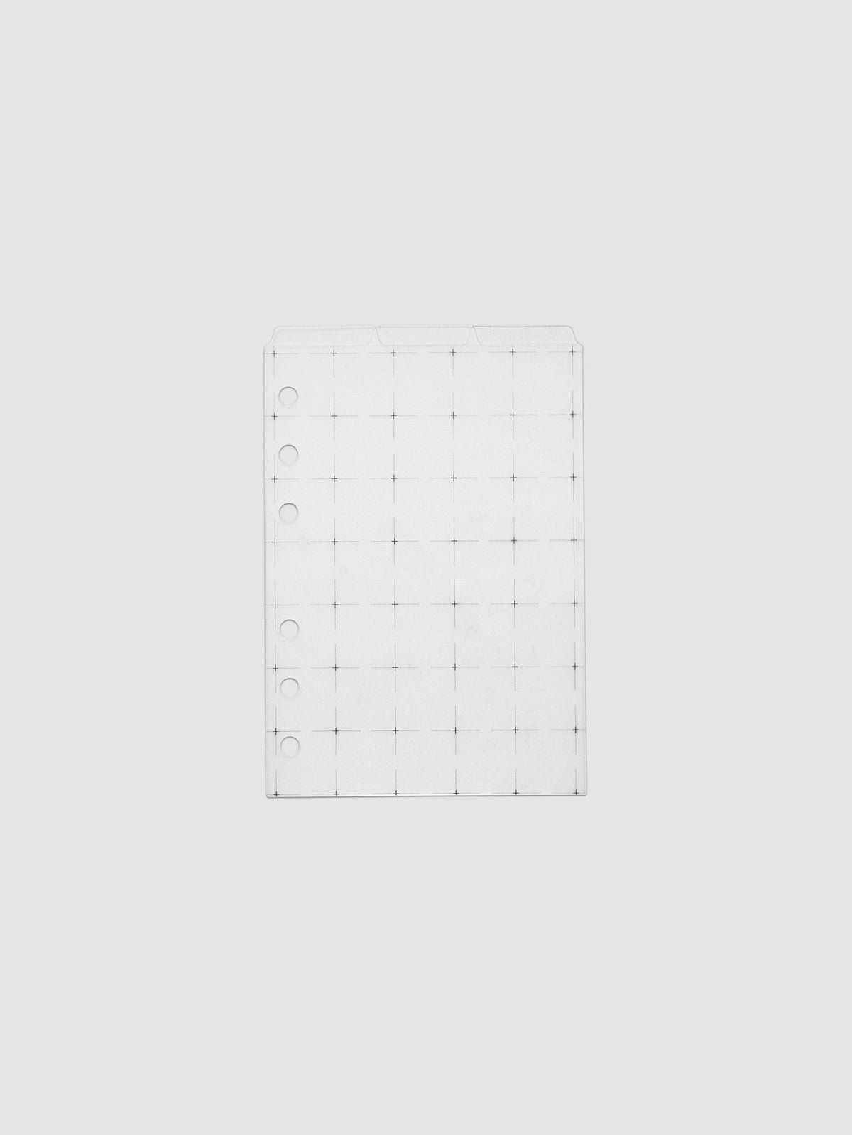 Grid Top Tab Dividers | Ultra-Thin, A6 6-Ring Punch, three frosted white dividers stacked flat against a pale grey ground, three staggered top tabs and black crosshair grid print