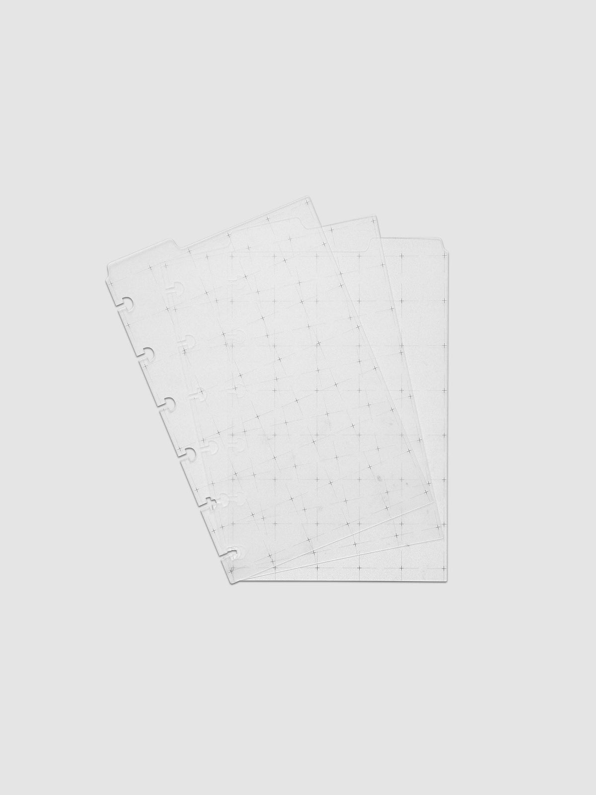 Grid Top Tab Dividers | Ultra-Thin, CP Petite 6-Disc Punch, the three dividers fanned at an angle, disc notches and black grid print showing through the translucent white plastic