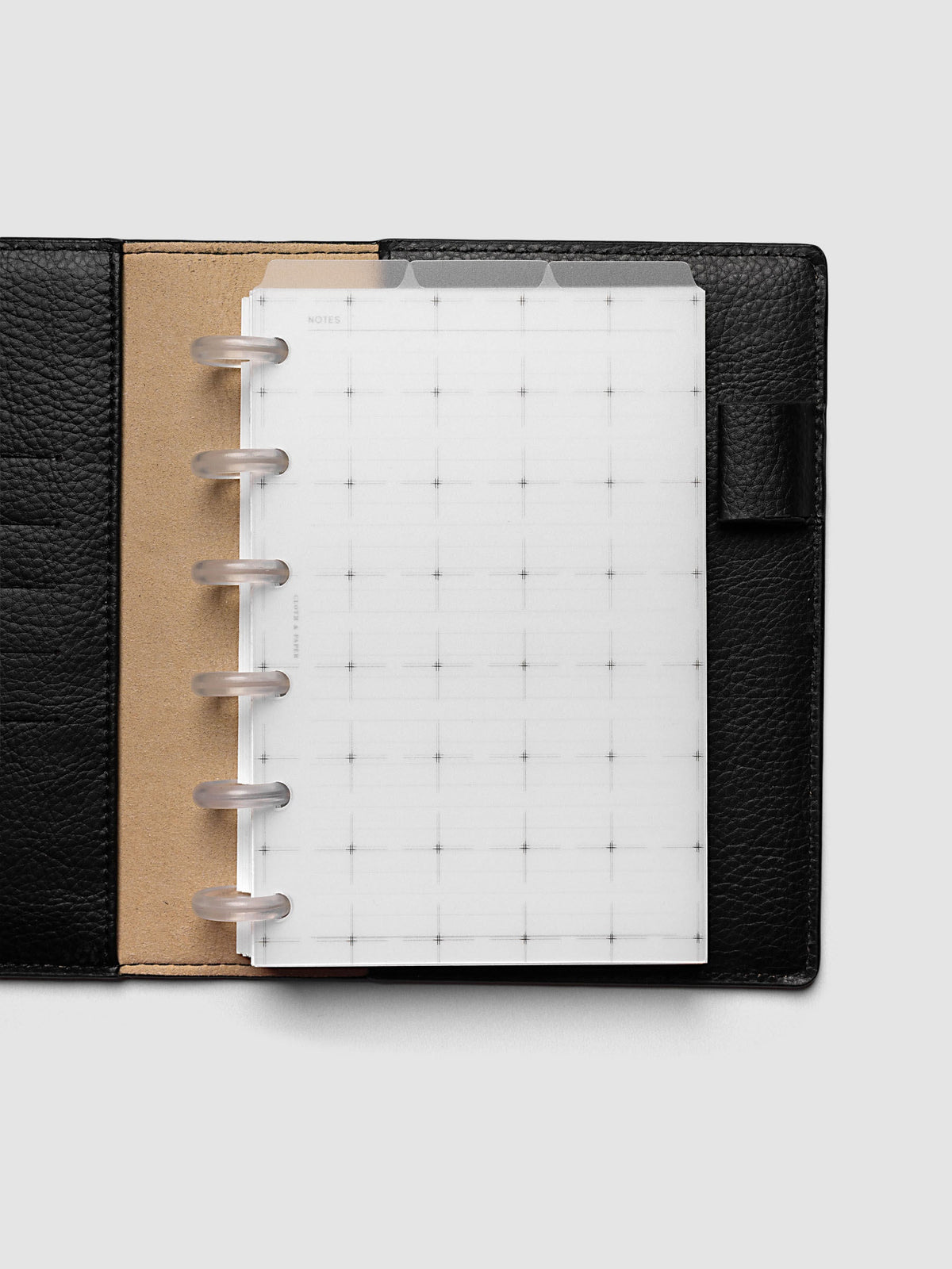 Grid Top Tab Dividers | Ultra-Thin, CP Petite 6-Disc Punch, dividers in an open black leather discbound planner with six frosted clear discs and a tan suede interior