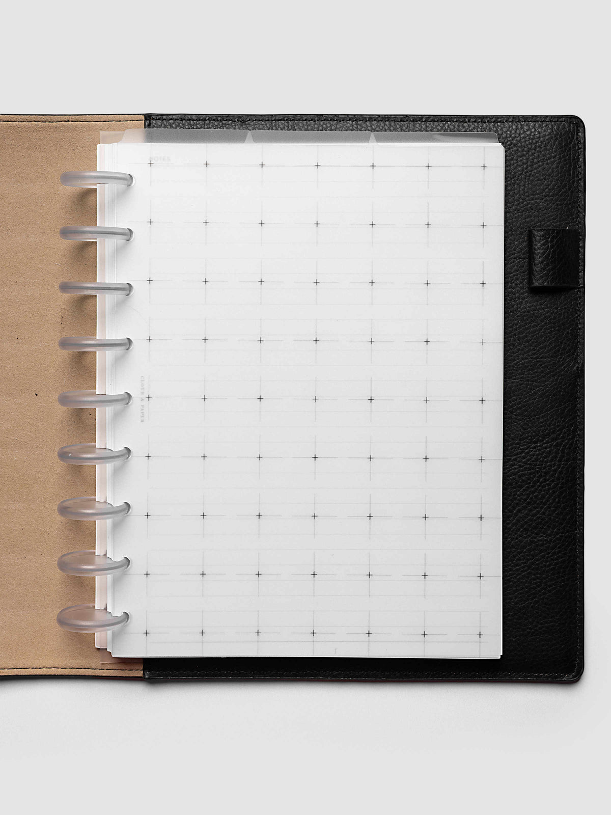 Grid Top Tab Dividers | Ultra-Thin, HP Classic 9-Disc Punch, dividers in an open black leather discbound planner with nine frosted clear discs and a tan interior cover