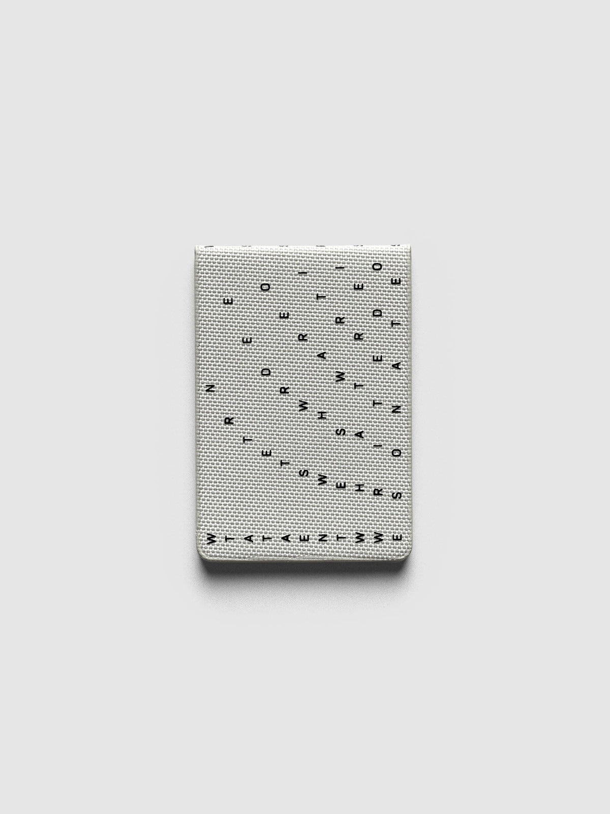 Magnetic Bookmarks Punched Holes & Margin, Margin bookmark folded, black letters scattered across grey bookcloth