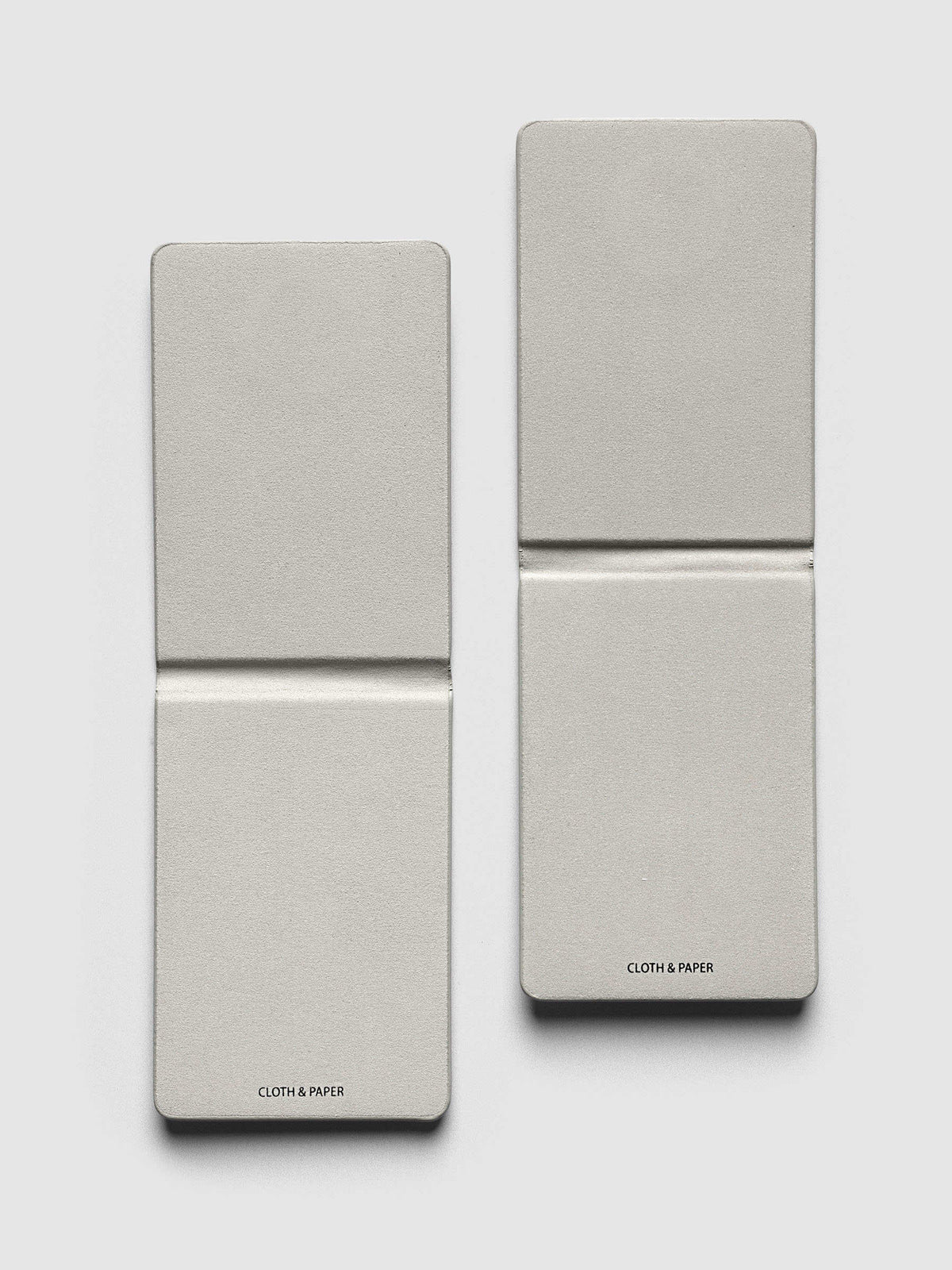 Magnetic Bookmarks Punched Holes & Margin, both bookmarks opened to show the soft grey fabric lining