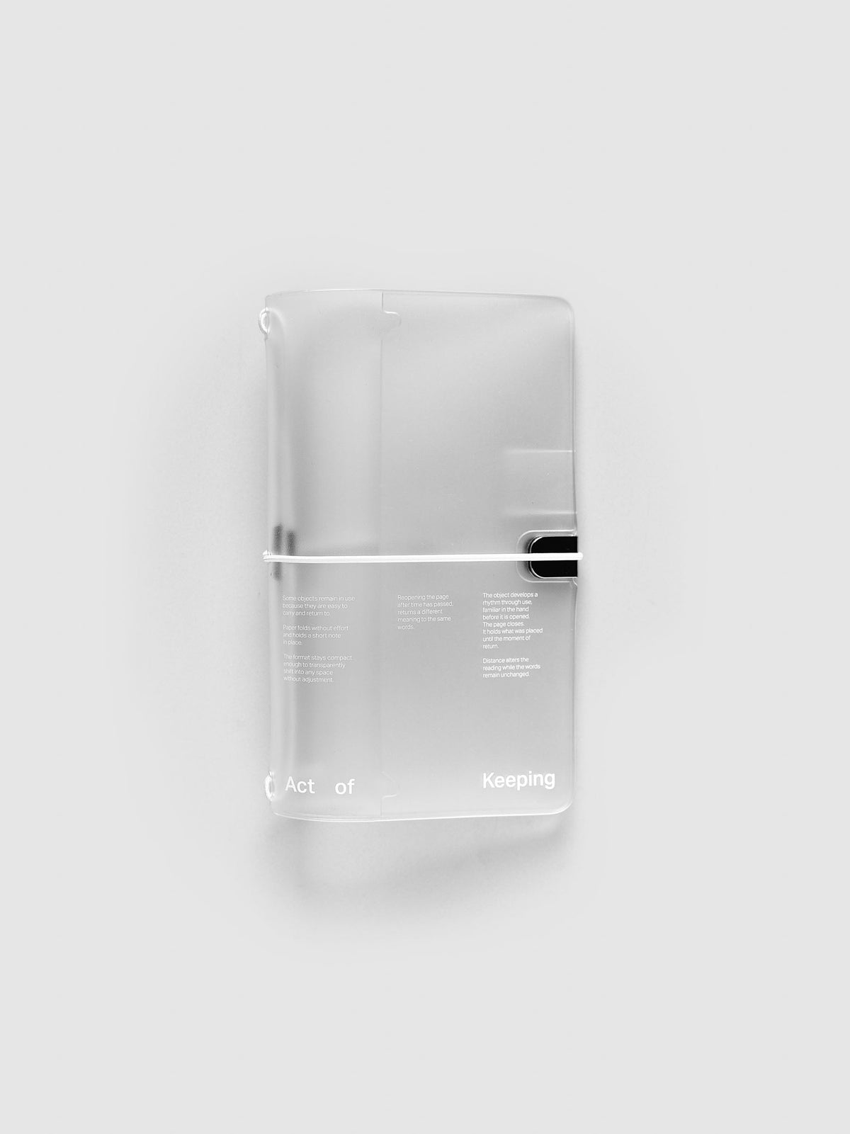 Act of Keeping Travel Cover, Pocket Plus, in frosted vinyl printed in white, closed with a white elastic cord and black clip