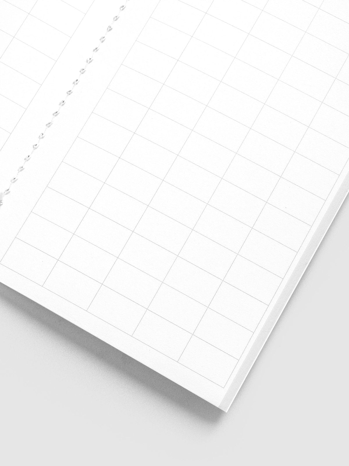 Close-up of the large graph grid and white stitched binding inside the Tangent A5 Slim Travel Notebook