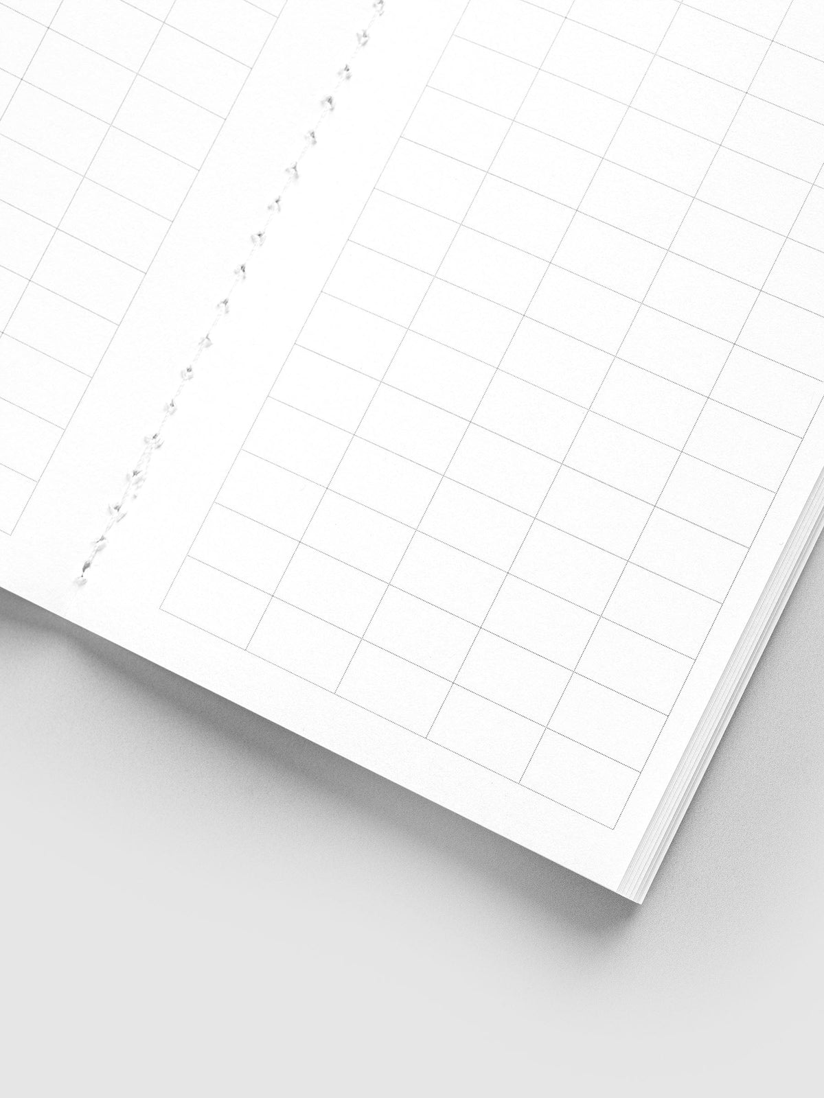 Close-up of the large graph grid and white stitched binding inside the Tangent Pocket Plus Travel Notebook