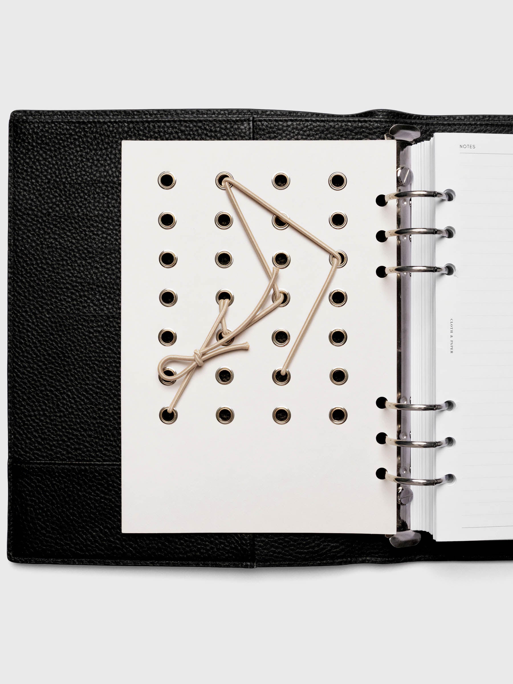 Cadence Dashboard with grommets and string on beige cardstock shown in size A5 for 6-ring planners and notebooks.