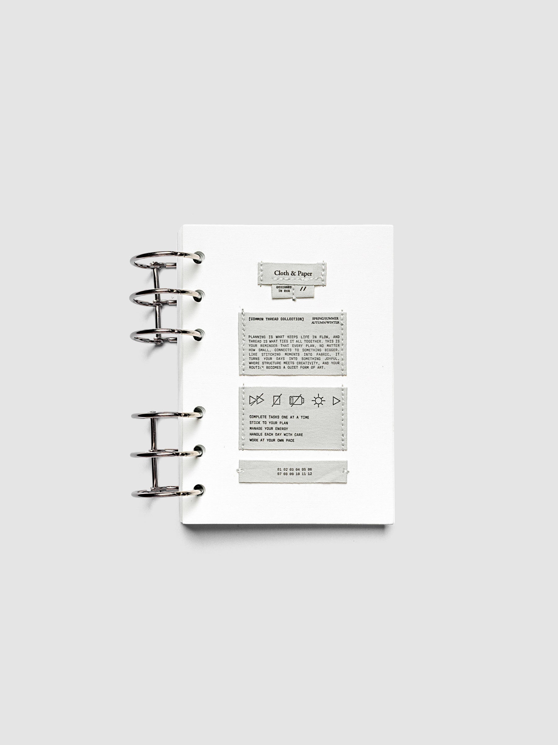Sewn Tags Planner Dashboard pre-punched for 6-ring planners in size A6 shown ring bound.