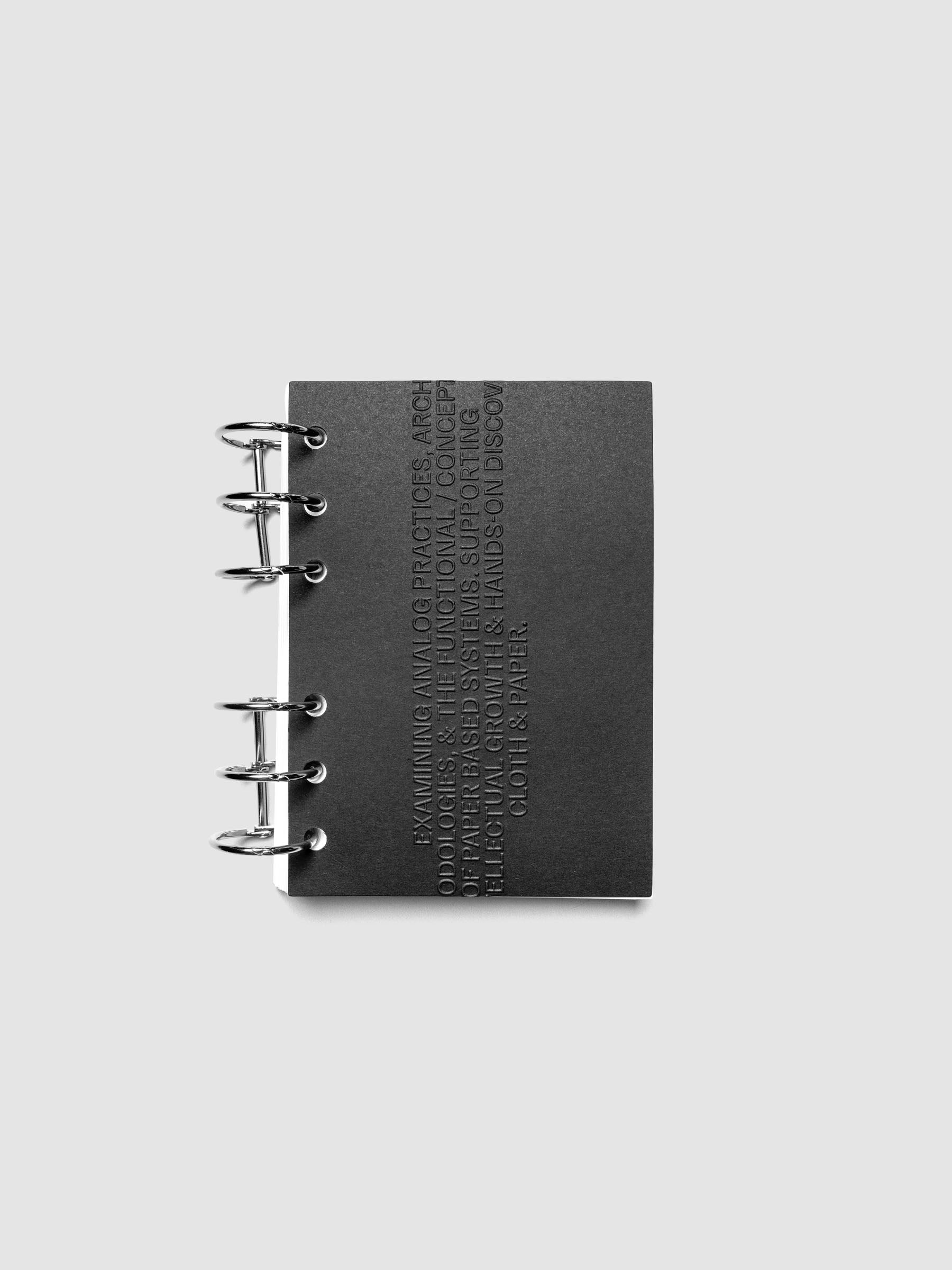 Black embossed Analog Embossed Planner Dashboard without drop card shown in size A6.