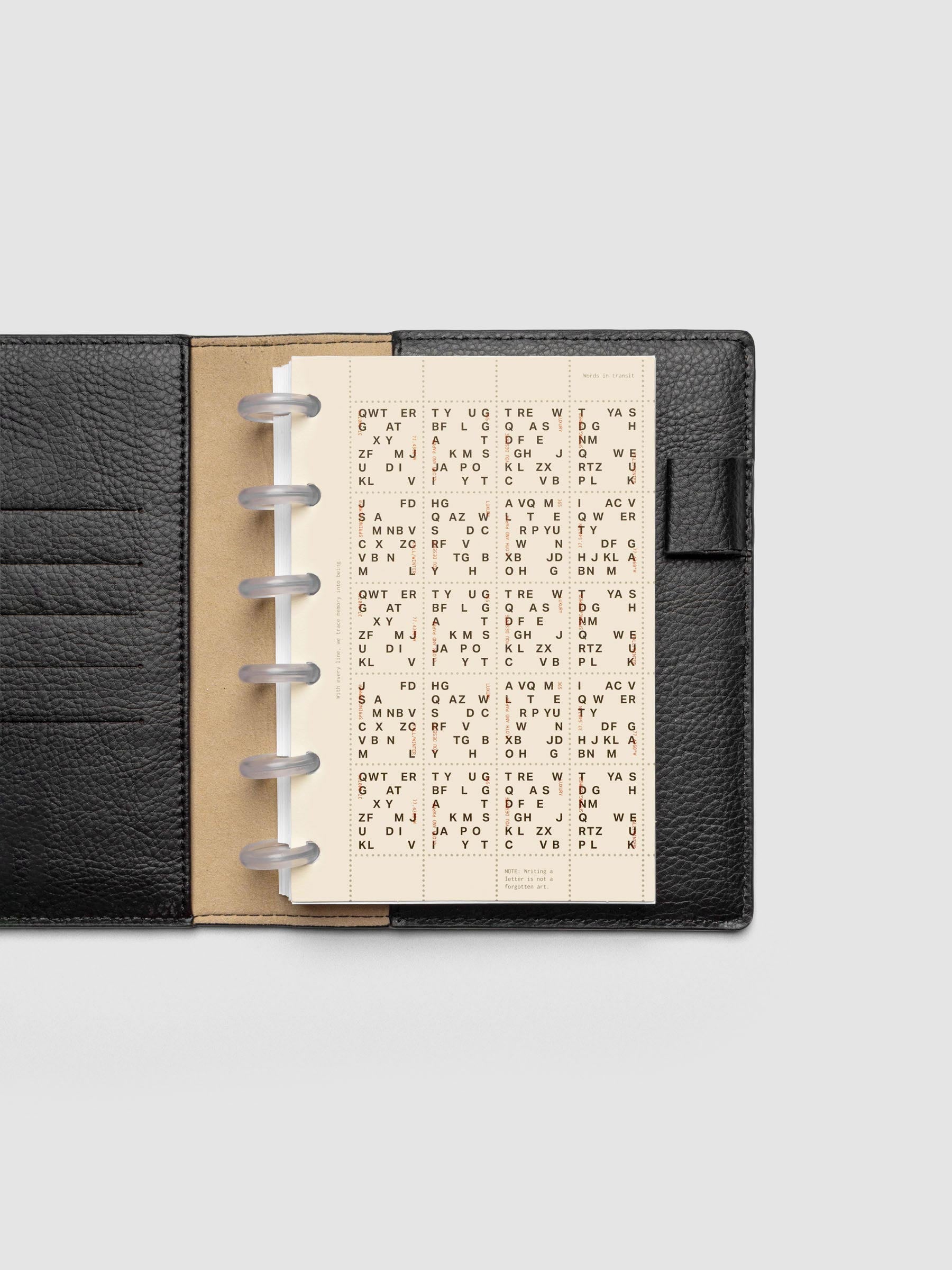 Stamp Sheet Planner Dashboard shown in a CP Petite black leather folio.