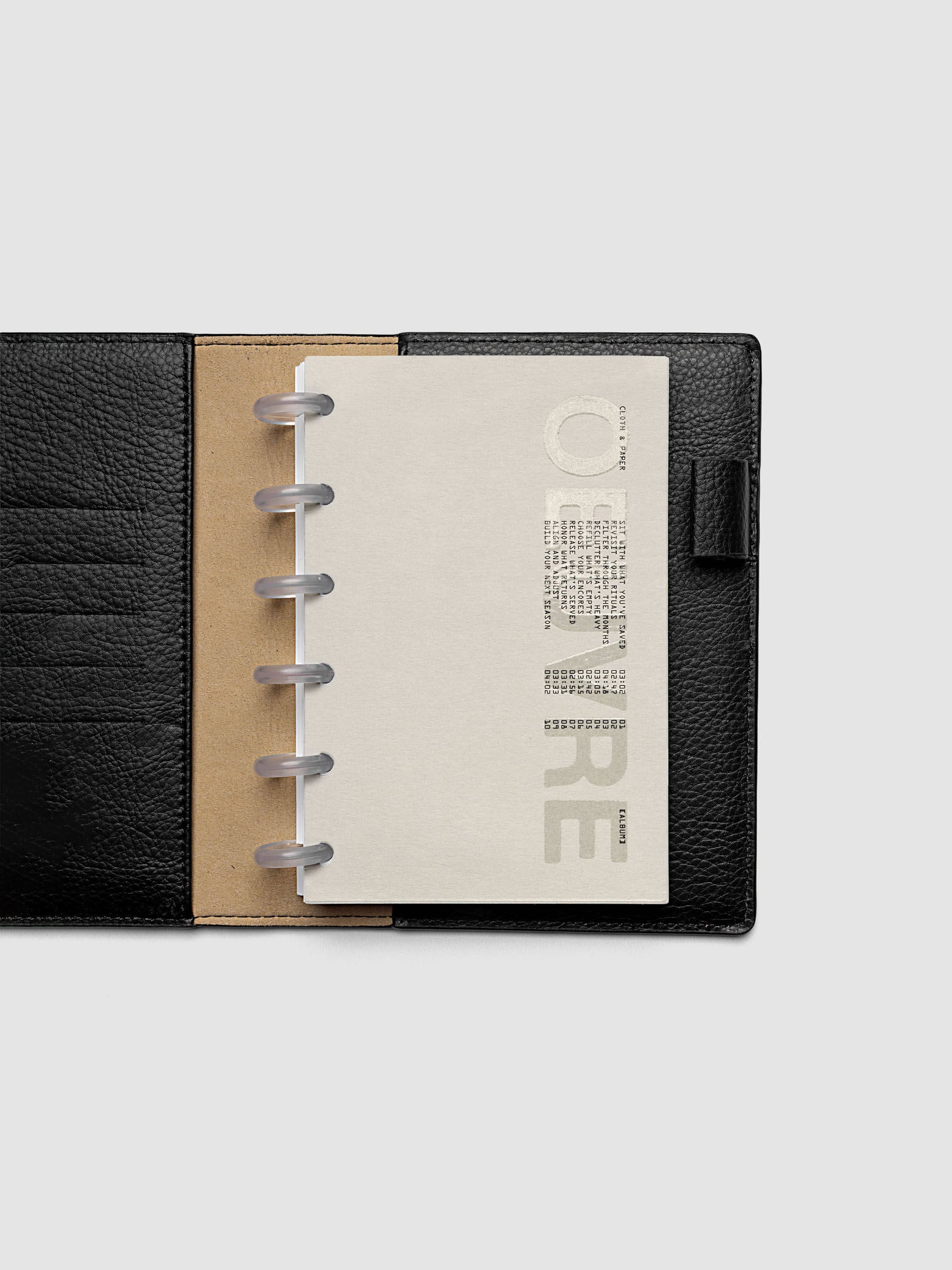 Oeuvre Planner Dashboard in CP Petite 6-Disc Punch size shown in a planner