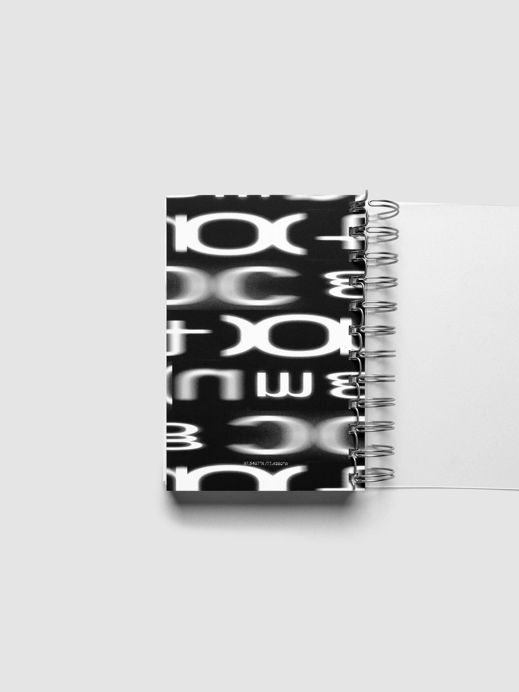 Spiral Notebook dashboard in the pattern Blurred Letters shown in size CP Petite inside a notebook.
