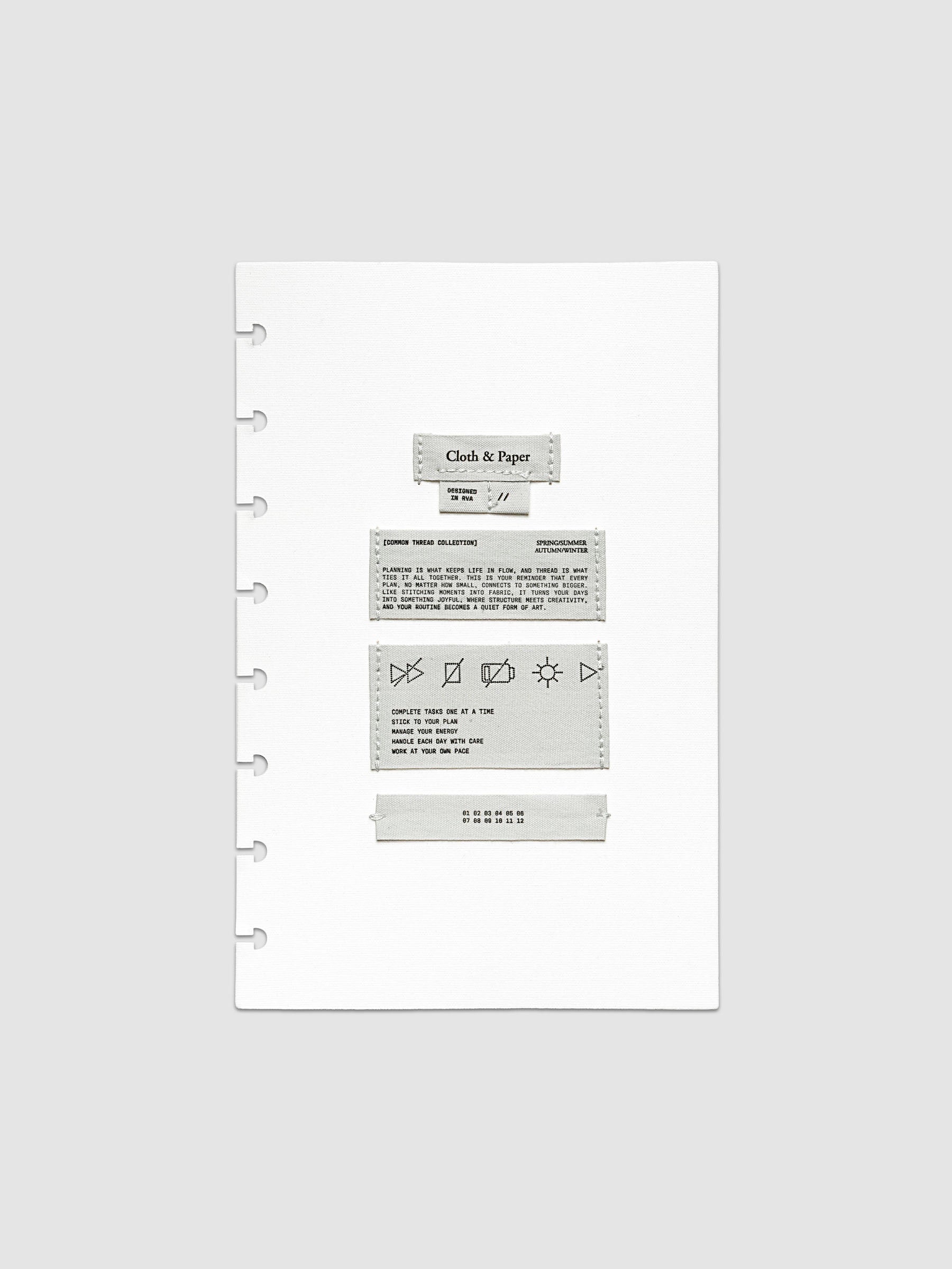 Sewn Tags Planner Dashboard shown pre-punched for discbound planners in size Half Letter.