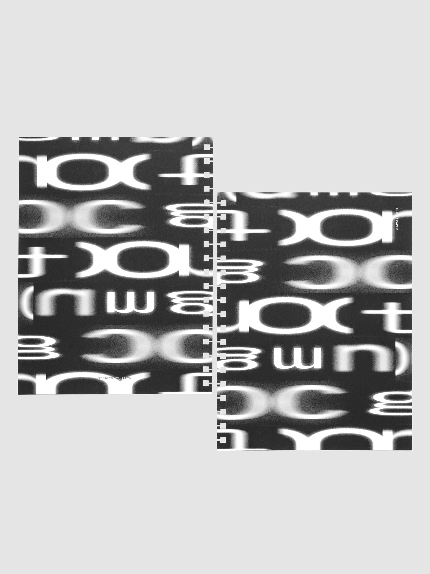 Front and back Spiral Notebook dashboards in the pattern Blurred Letters shown in size HP Classic against a neutral background.