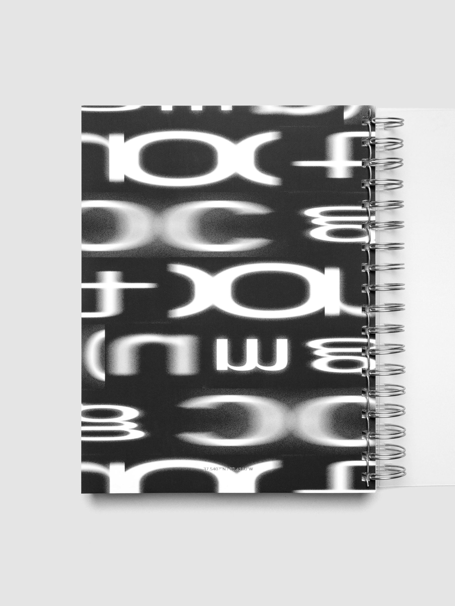 Spiral Notebook dashboard in the color Le Blanc shown in size CP Petite inside a notebook.