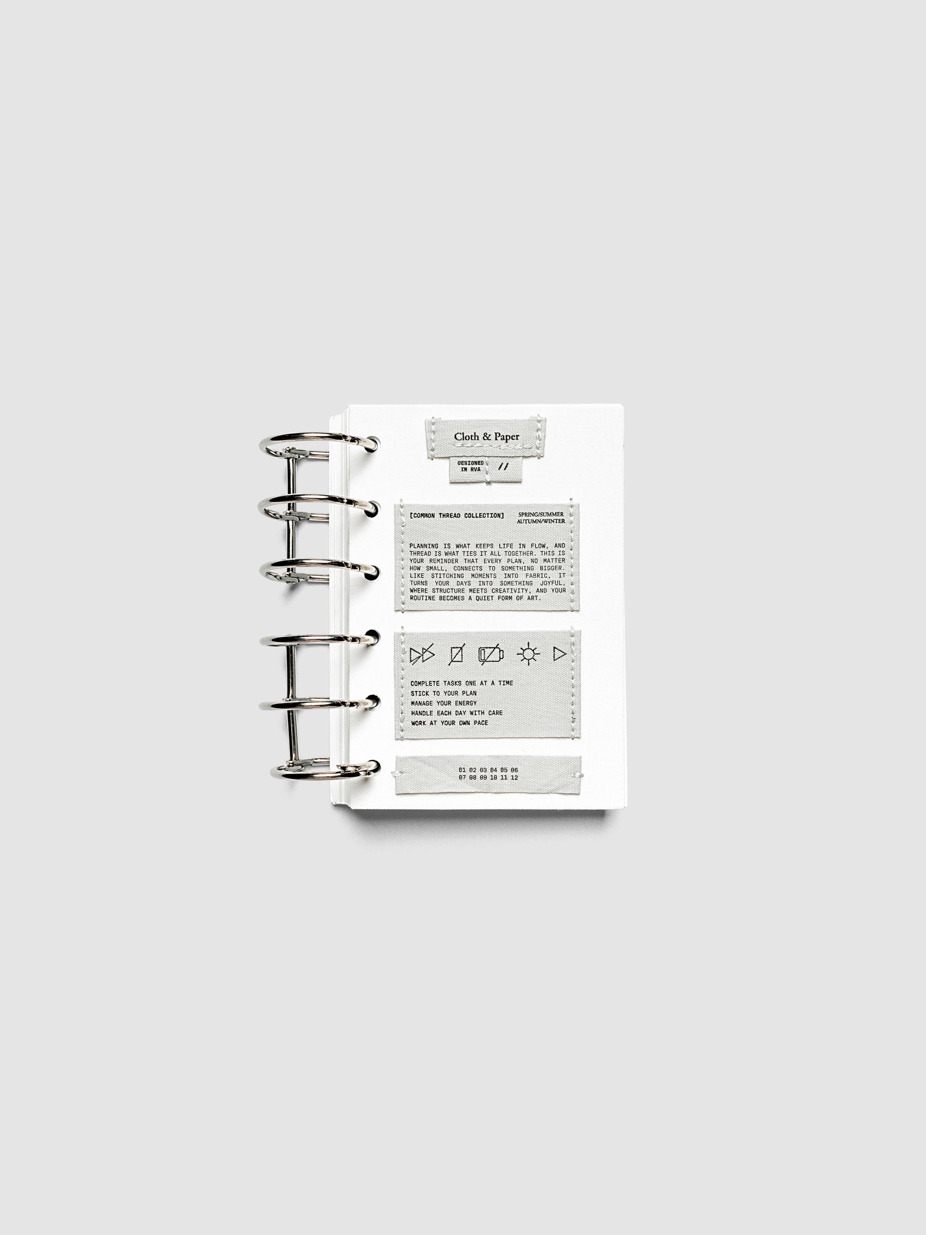 Sewn Tags Planner Dashboard pre-punched for 6-ring planners in size Pocket shown ring bound.