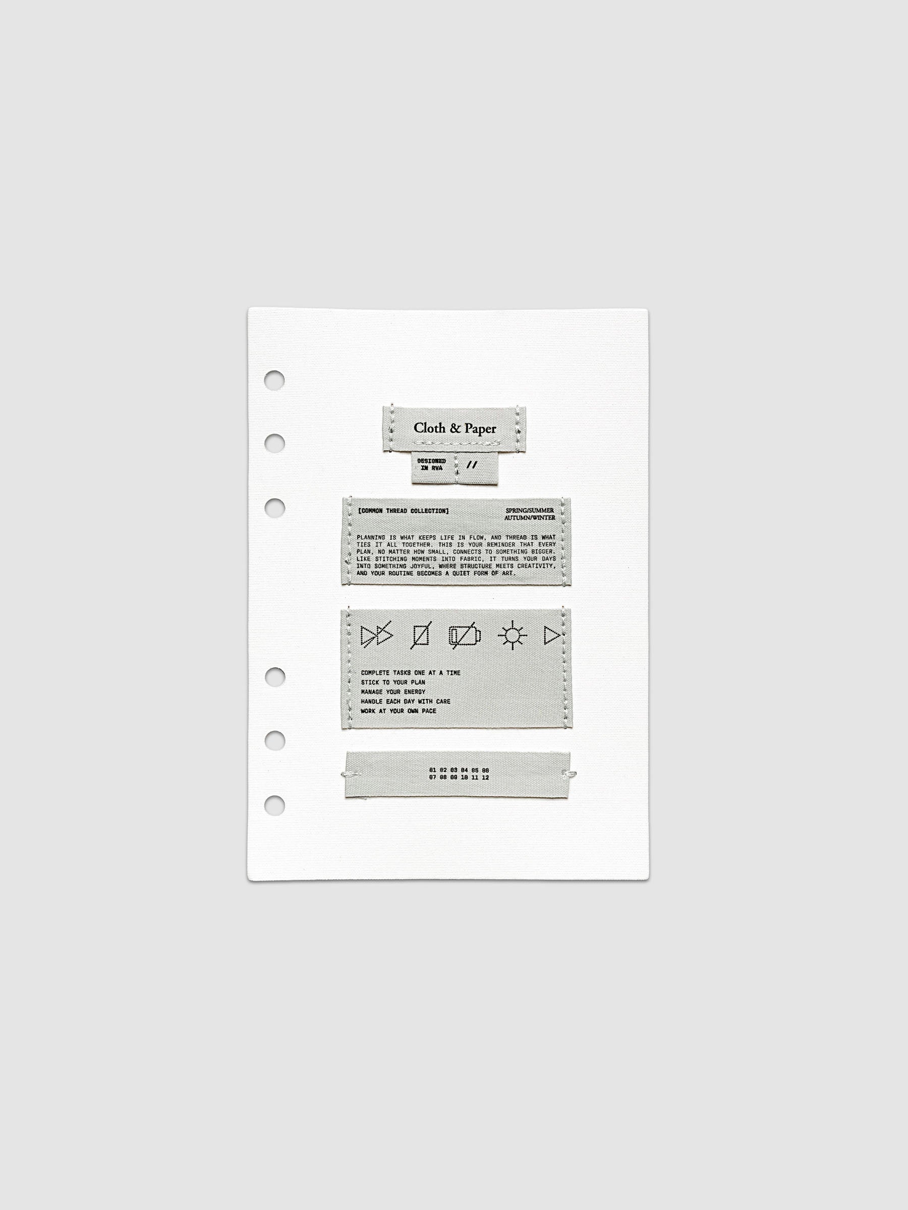 Sewn Tags Planner Dashboard shown pre-punched for 6-ring planners in size Personal Wide.
