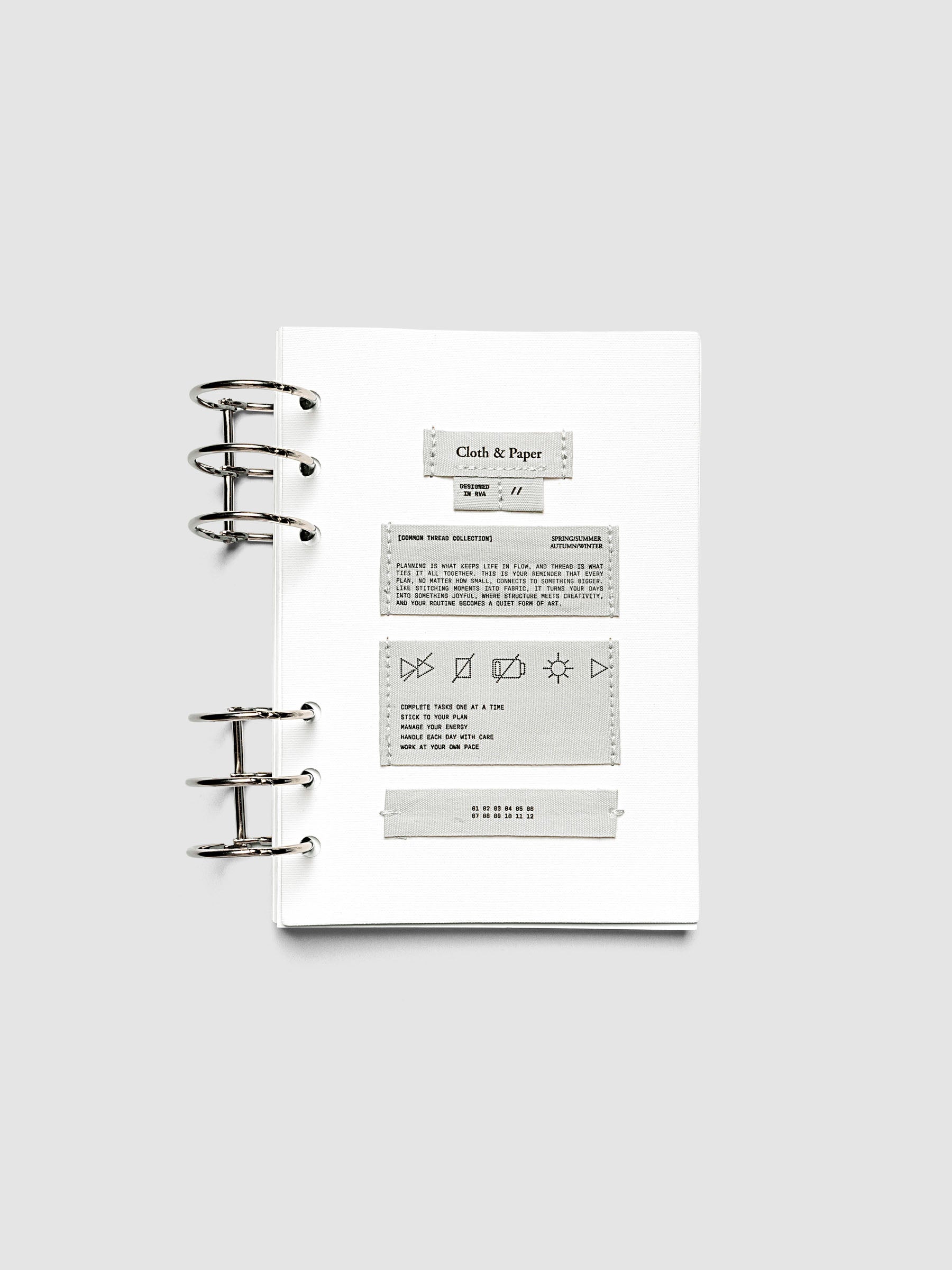 Sewn Tags Planner Dashboard pre-punched for 6-ring planners in size A5 shown ring bound