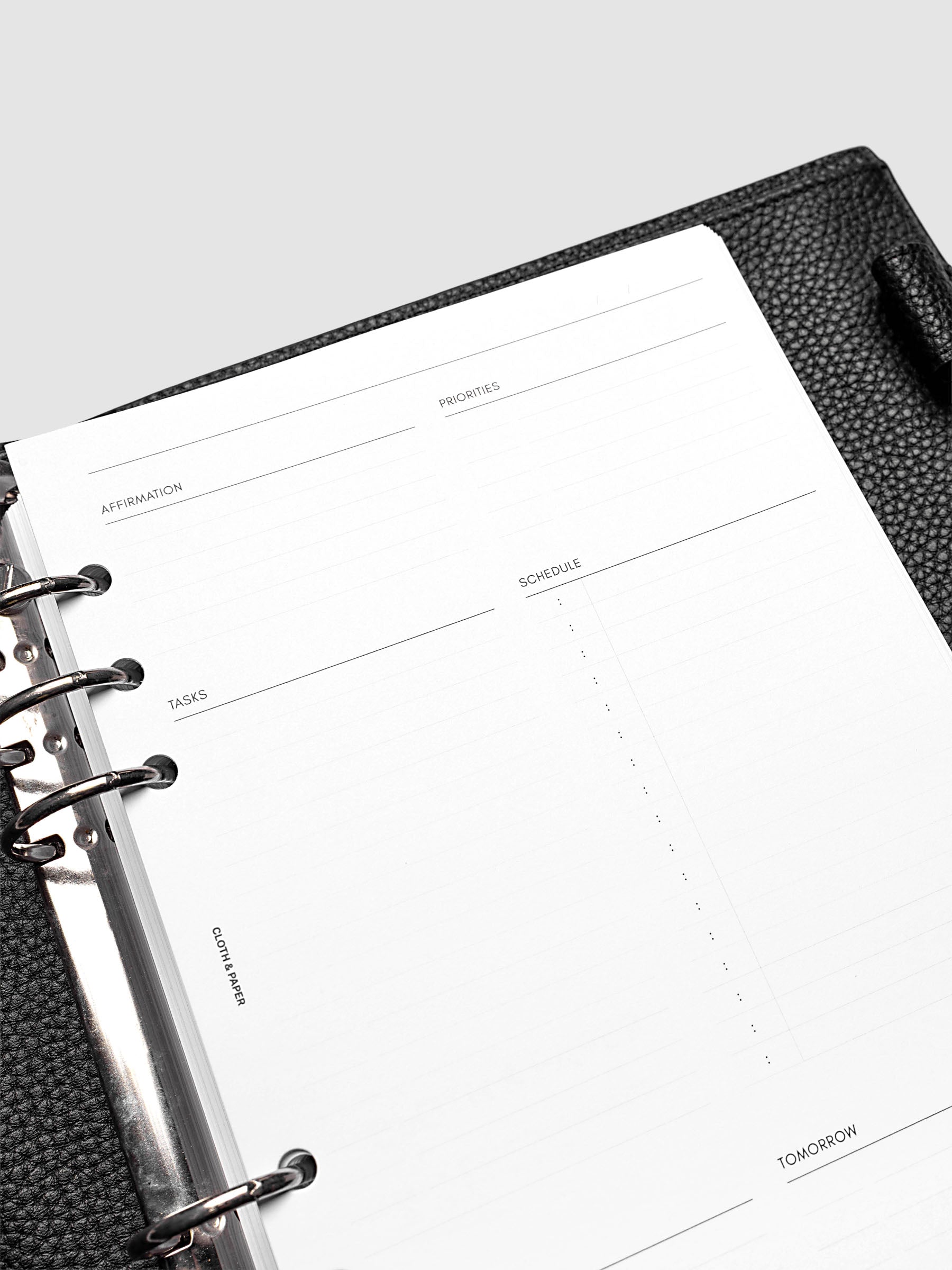 Close up of a blank Daily Essentials Planner insert inside an A5 black agenda.