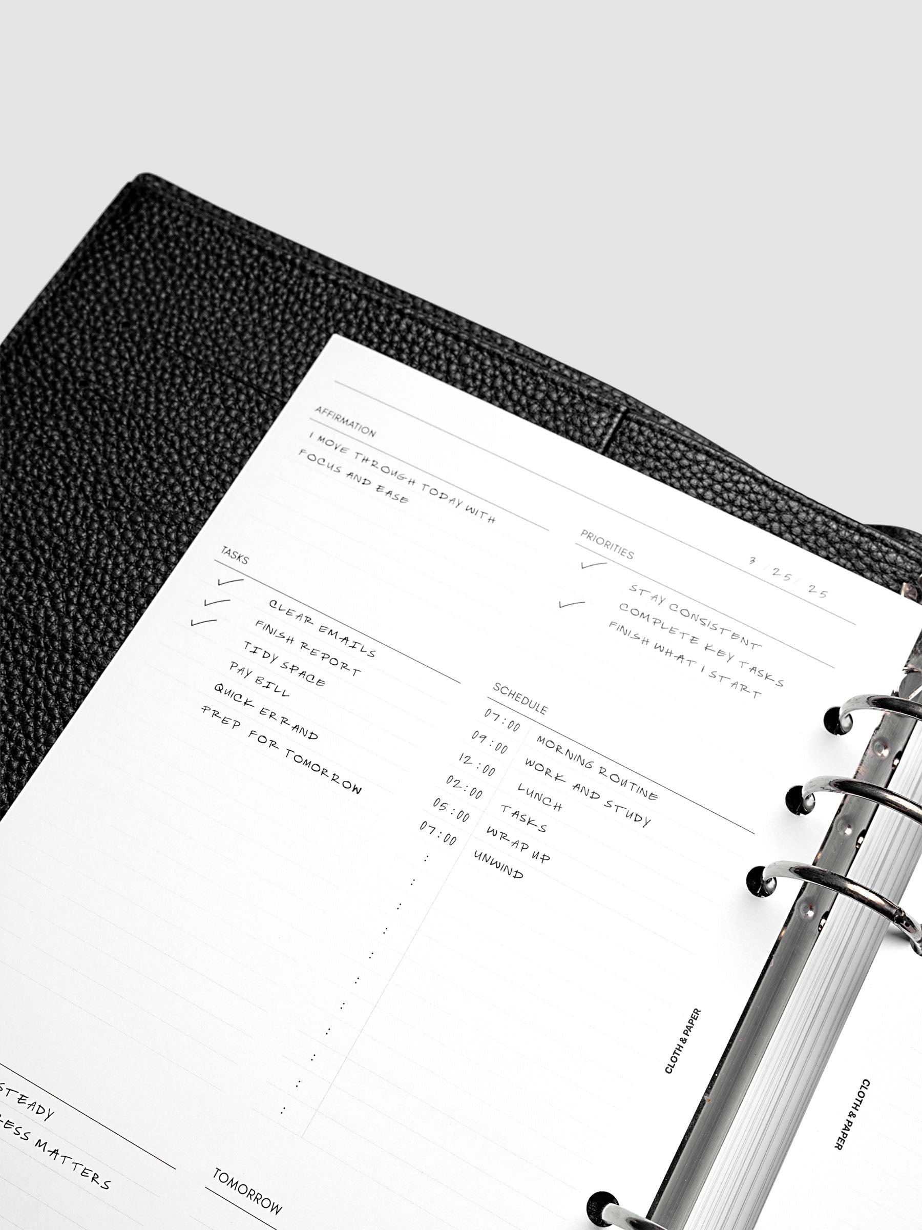 Close up of the demo page for the Daily Essentials Planner insert inside an A5 black agenda.