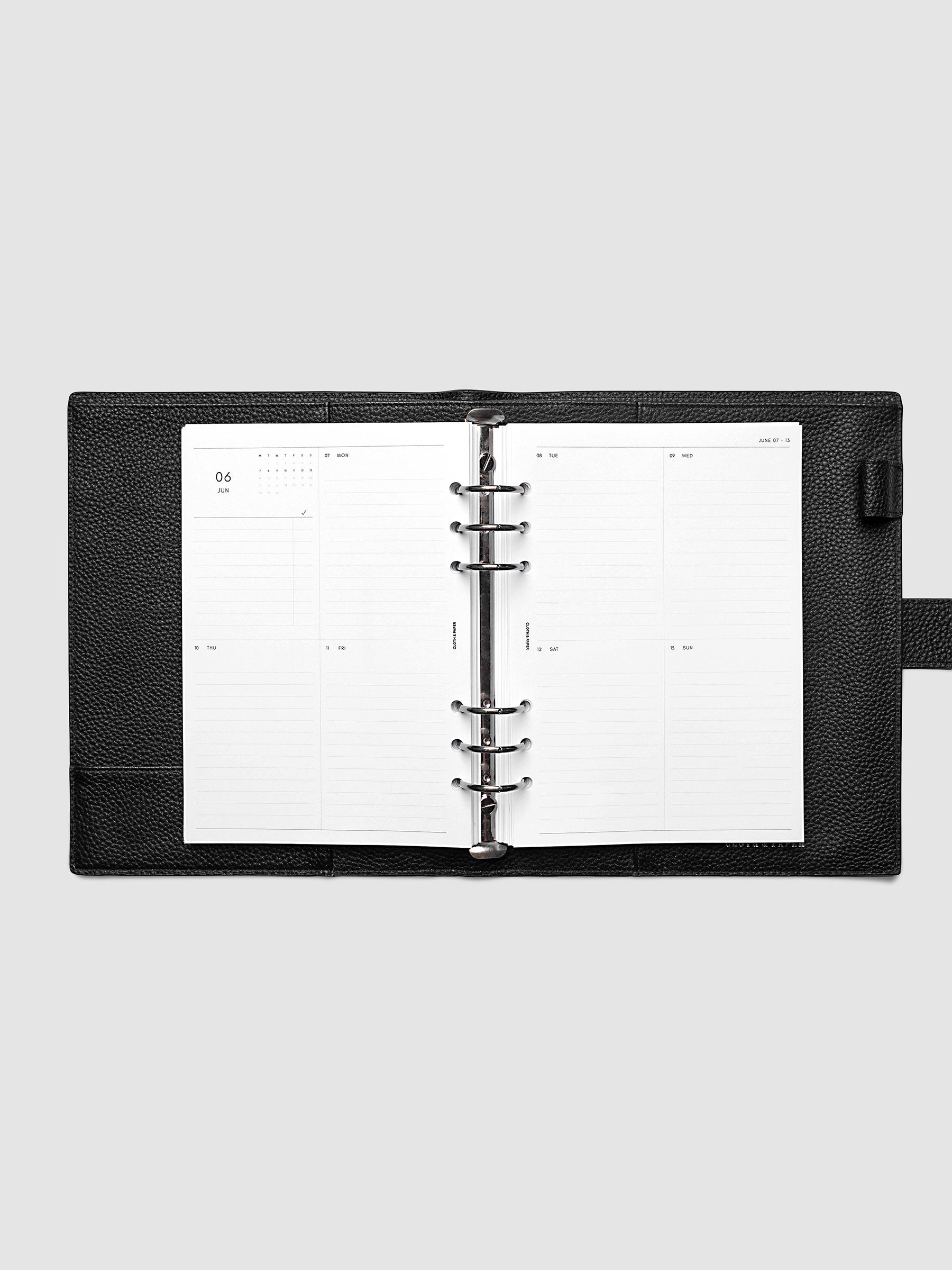 Both pages inside planner: 2027 Dated Weekly Vertical Planner Inserts, Monday Start, A5 6-Ring Punch, full week-on-two-pages spread showing a two-column two-row daily grid with lined sections, mini monthly calendar and task list in the top left, shown inside a planner