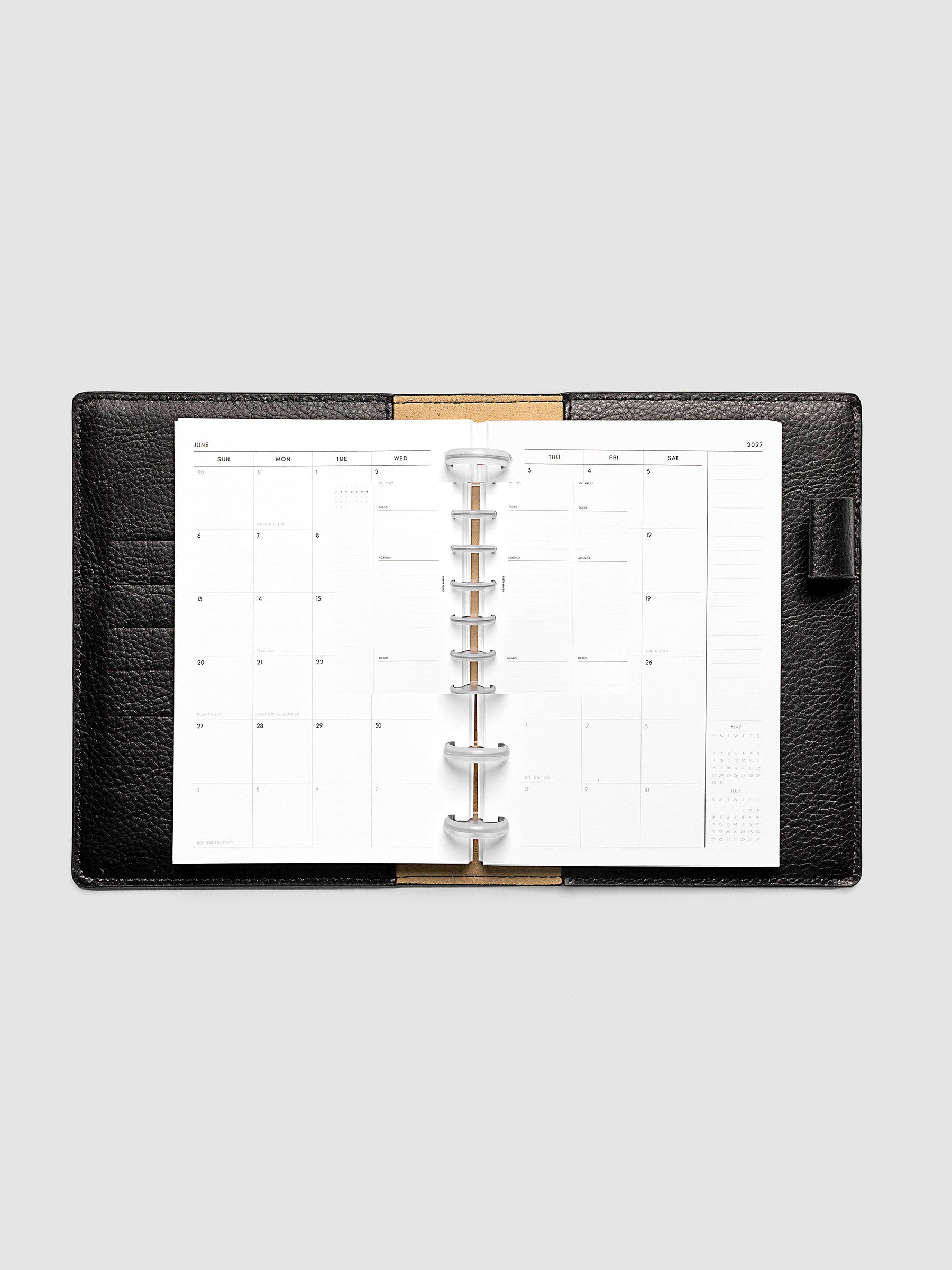 Open planner showing the full two-page 2027 Dated Monthly Sunday Start spread in CP Petite 6-Disc Punch size, with calendar grid, notes column, and mini calendars in the bottom right corner
