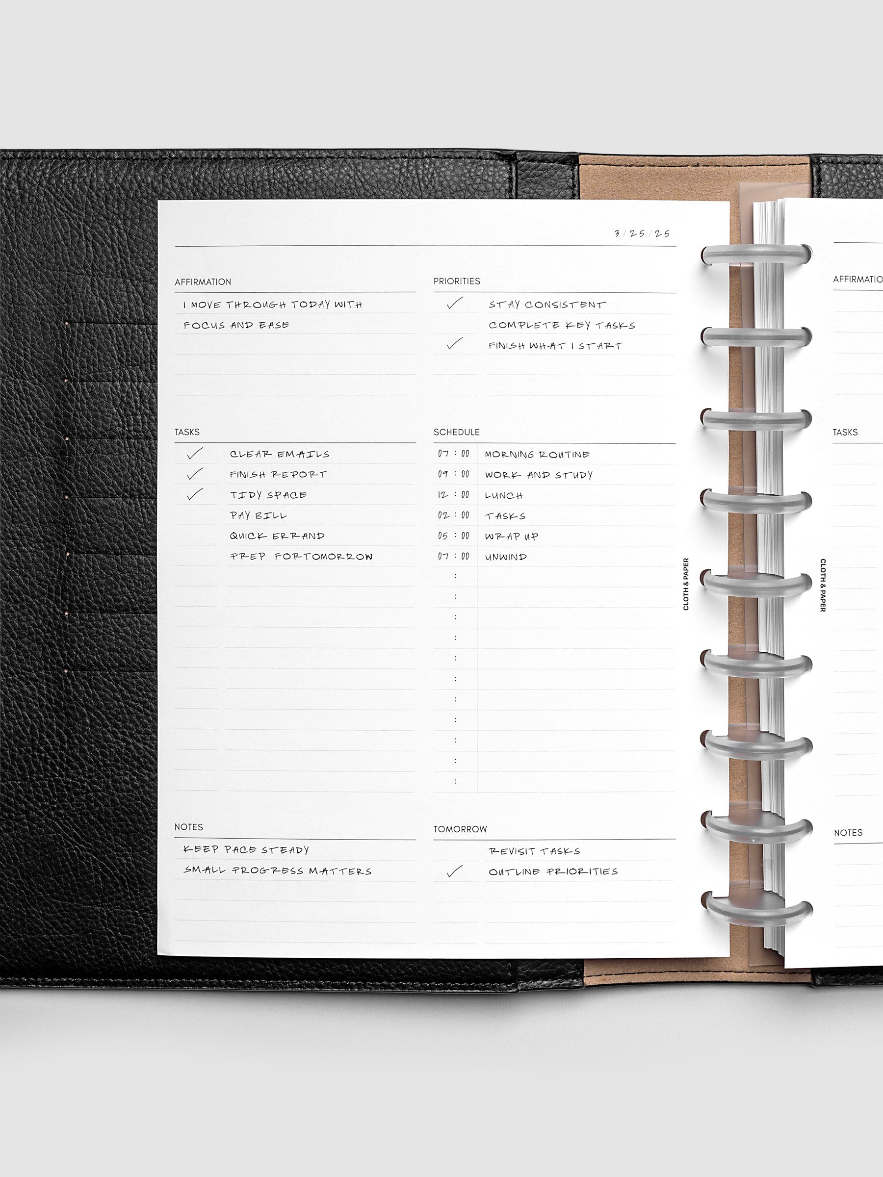Demo page for the Daily Essentials Planner Inserts shown in size HP Classic inside a black folio.