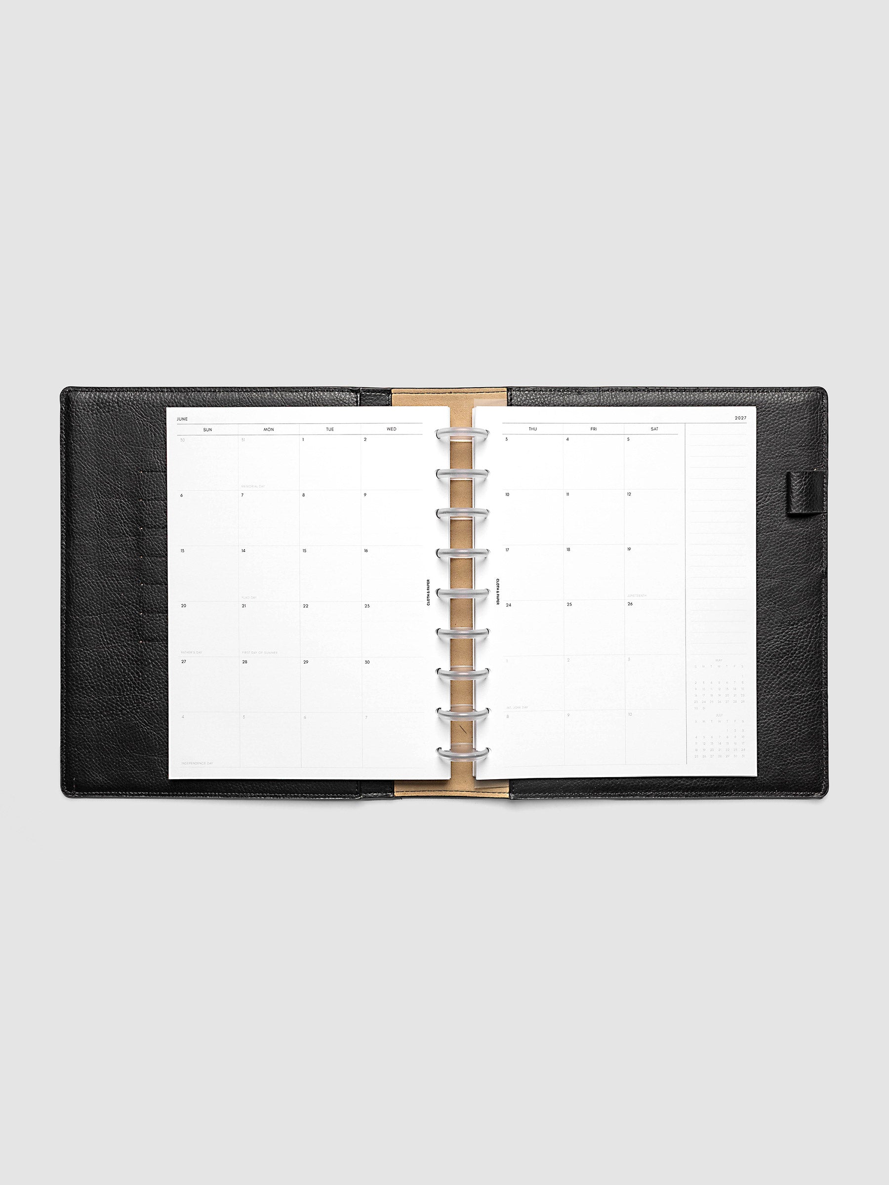 Open planner showing the full two-page 2027 Dated Monthly Sunday Start spread in HP Classic 9-Disc Punch size, with calendar grid, notes column, and mini calendars in the bottom right corner
