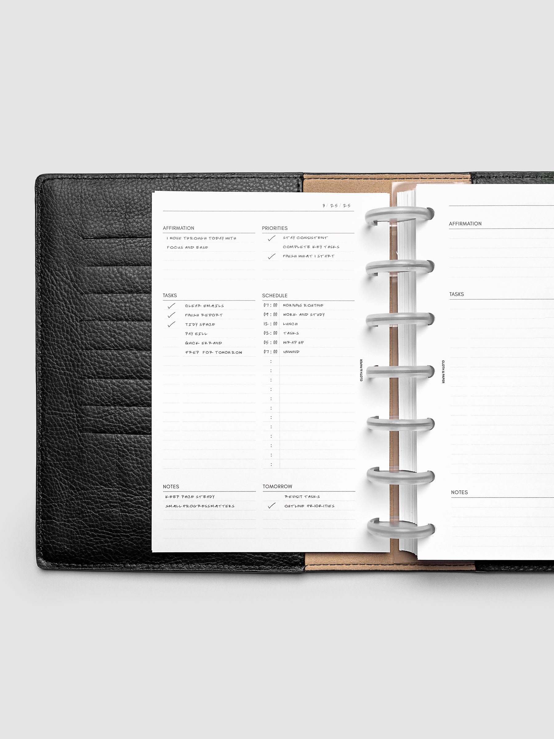 Demo page for the Daily Essentials Planner Inserts shown in size HP Mini inside a black folio.