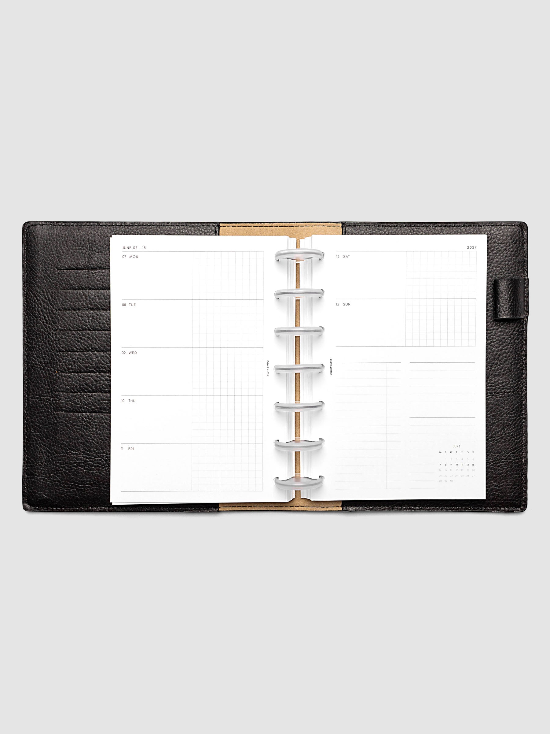 Open planner showing the full two-page 2027 Dated Weekly Horizontal Monday Start spread in HP Mini 7-Disc Punch size, with split open and graph daily columns on the left and weekend dates, tasks, notes, and mini monthly calendar on the right