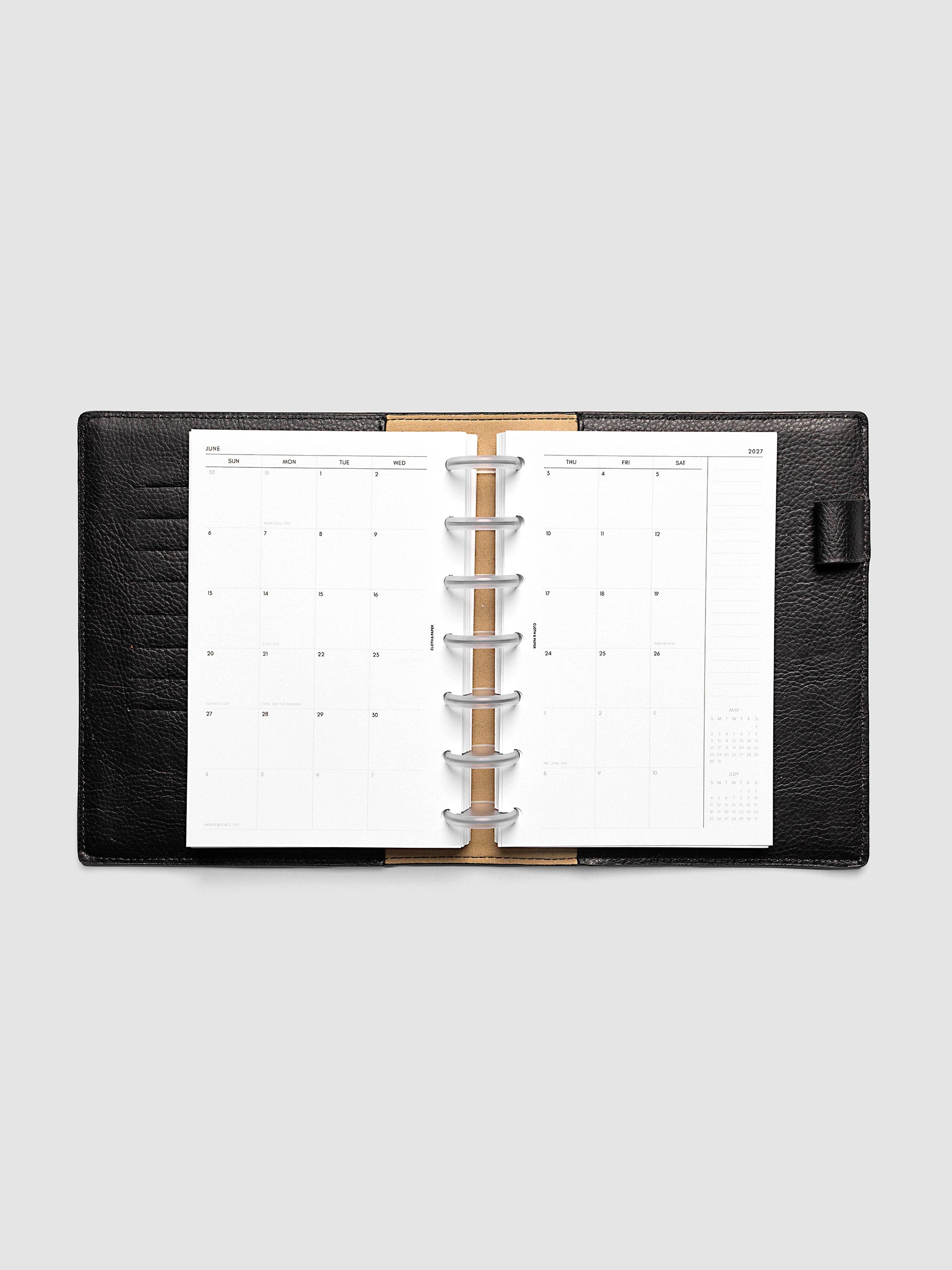 Open planner showing the full two-page 2027 Dated Monthly Sunday Start spread in HP Mini 7-Disc Punch size, with calendar grid, notes column, and mini calendars in the bottom right corner