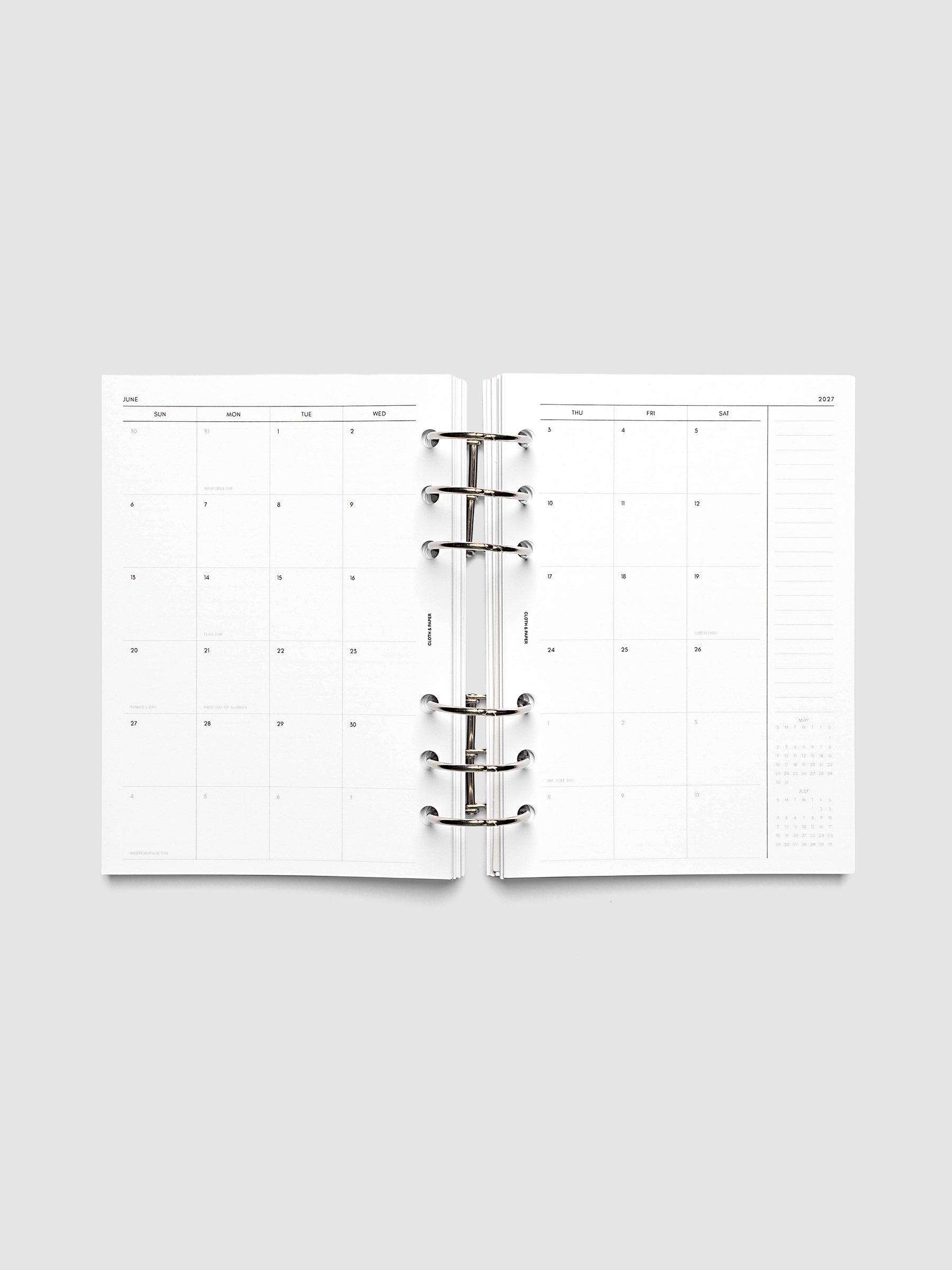 Open planner showing the full two-page 2027 Dated Monthly Sunday Start spread in Personal Wide 6-Ring Punch size, with calendar grid, notes column, and mini calendars in the bottom right corner