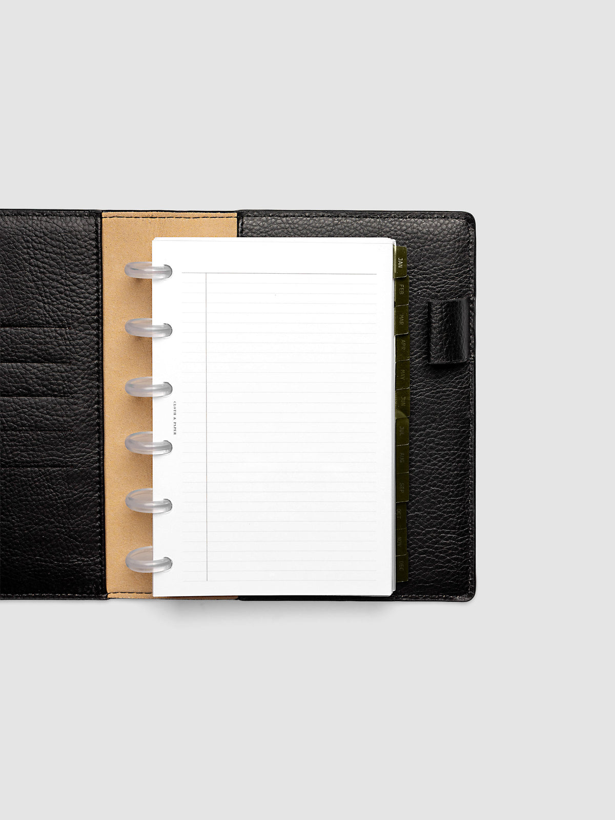 CP Petite 6-Disc Punch Ultra-Thin Monthly Dividers in olive green shown tabbed inside a planner