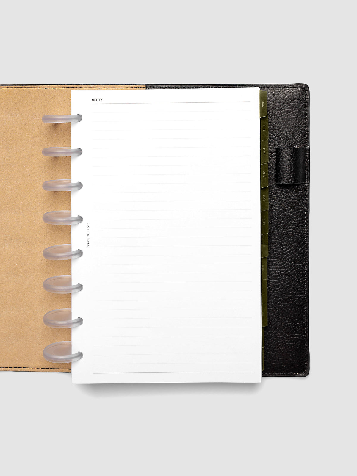 Half Letter 8-Disc Punch Ultra-Thin Monthly Dividers in olive green shown tabbed inside a planner