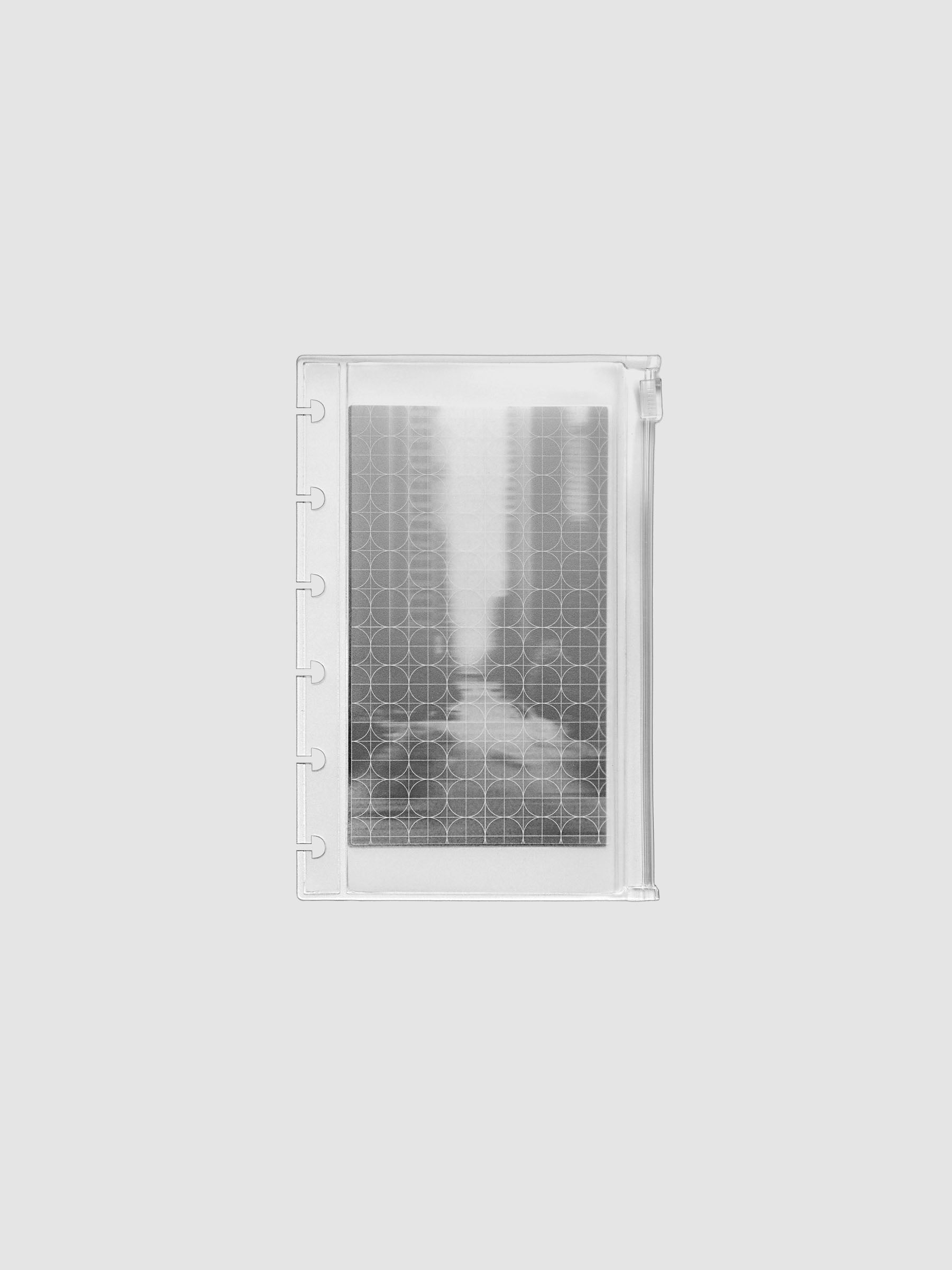 Zippered transparent pouch pre-punched for CP Petite size disc bound planners and notebooks. Features a graph and a photographic decorative inner insert.