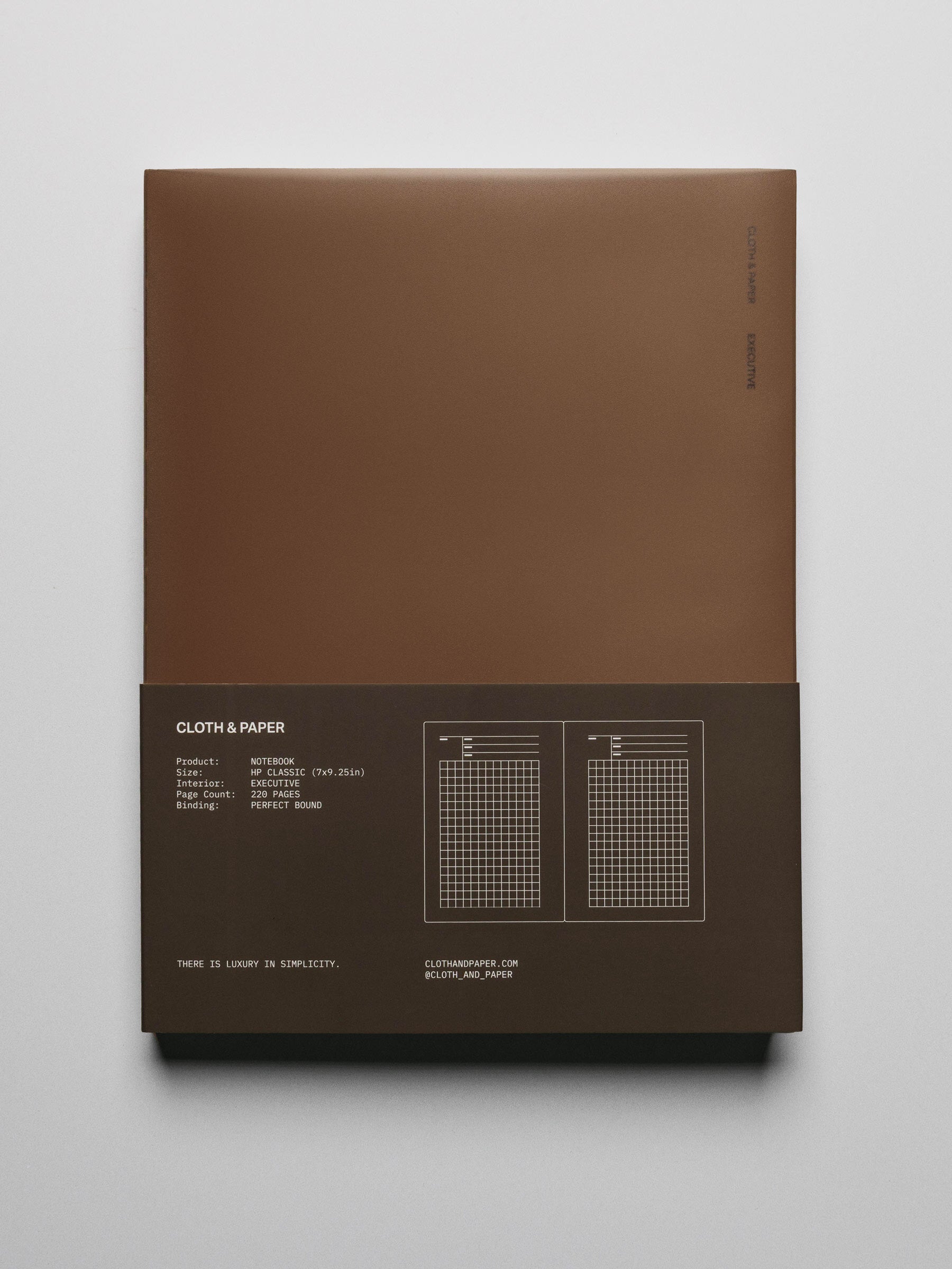 Perfect Bound Notebook in size HP Classic with Executive Notes pages and a brown cover shown closed from the front with packaging belly band.
