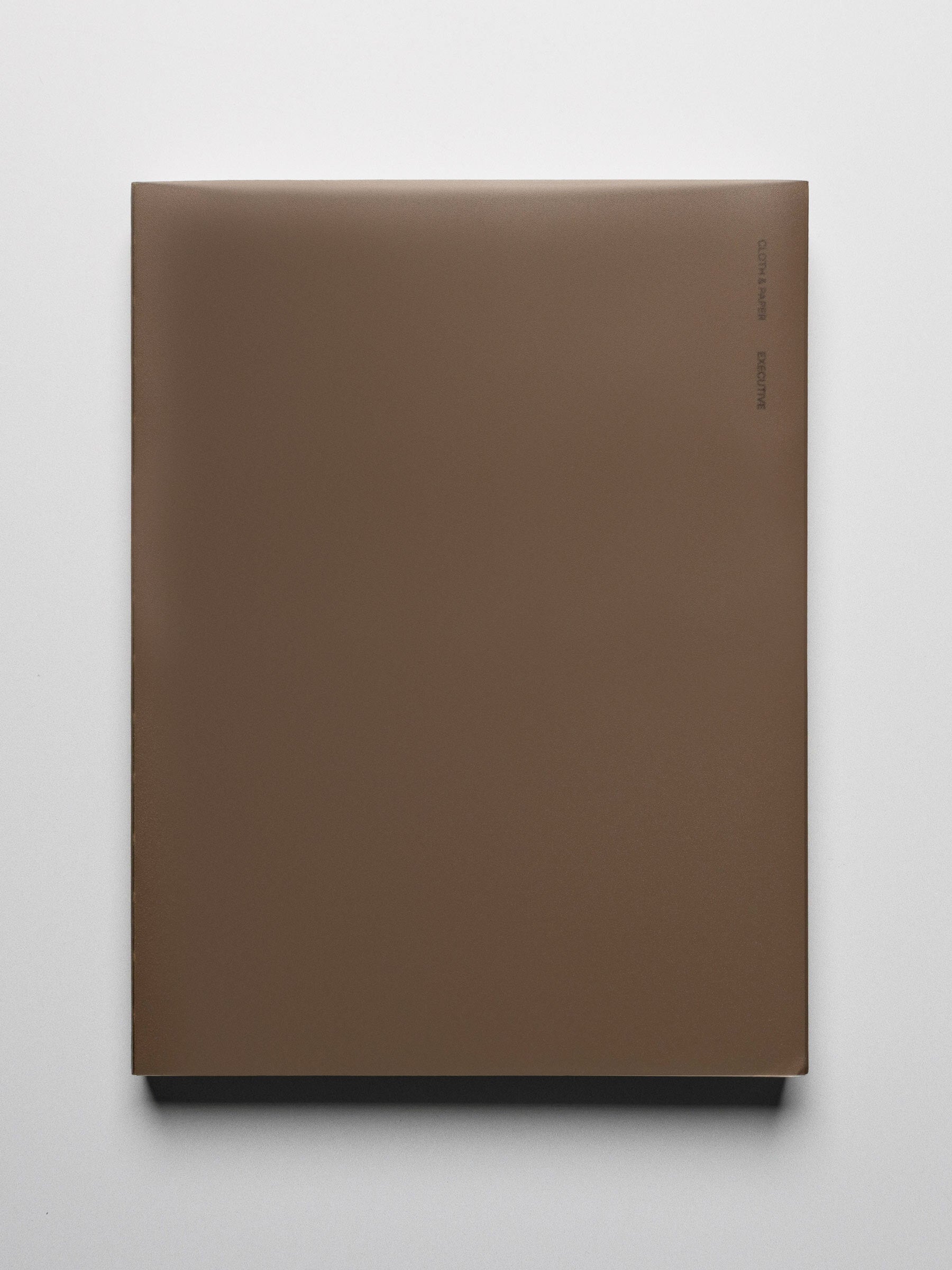 Perfect Bound Notebook in size HP Classic with Executive Notes pages shown closed from the front with a brown cover.