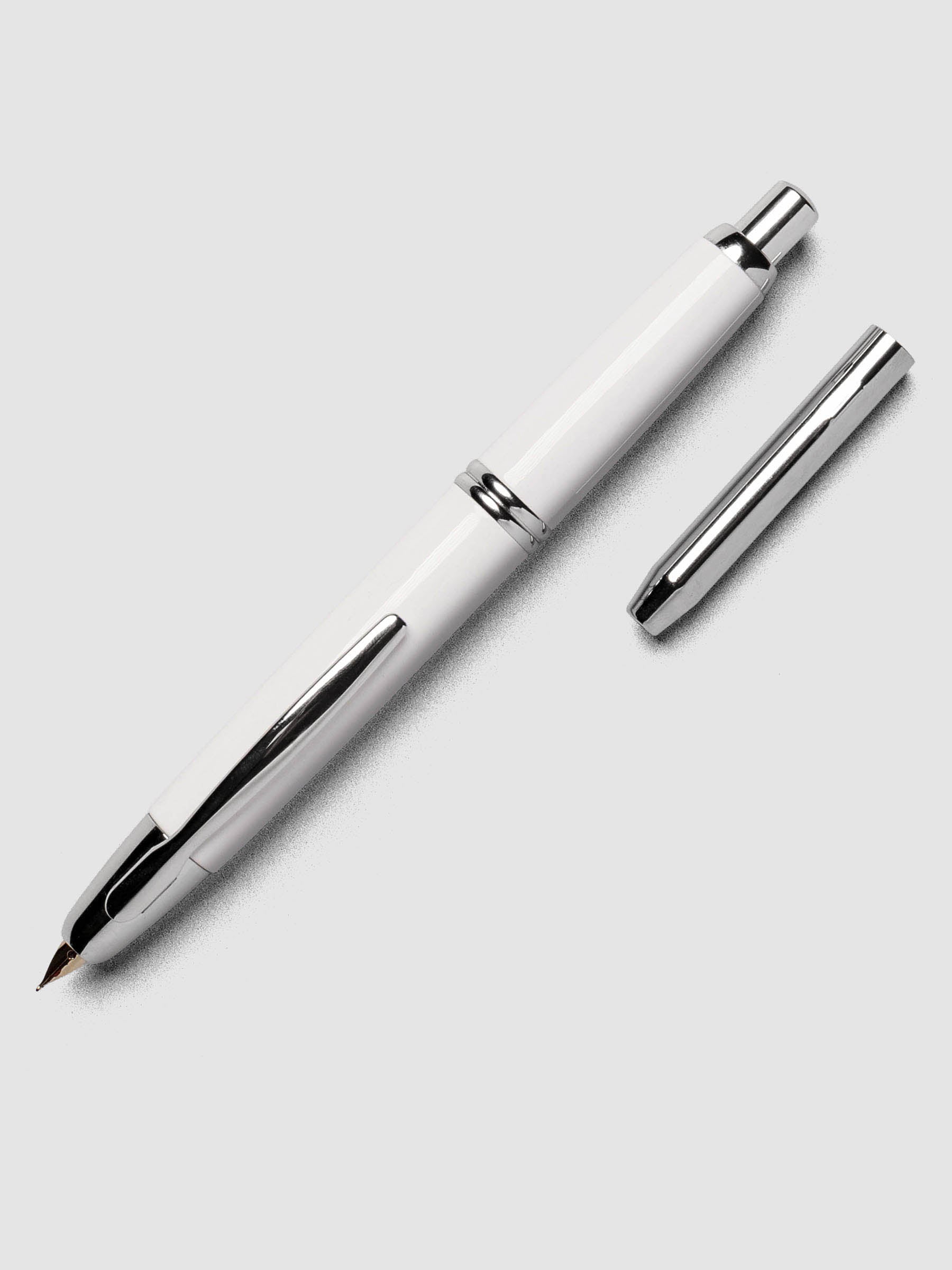 White Rhodium Pilot Vanishing Point Fountain Pen with cap off on a neutral background.