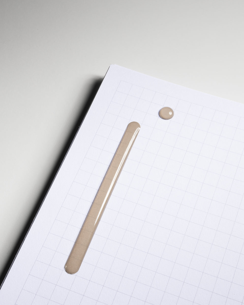 Raised Sticker Set in Cortado (light brown) shown in use on graph paper.